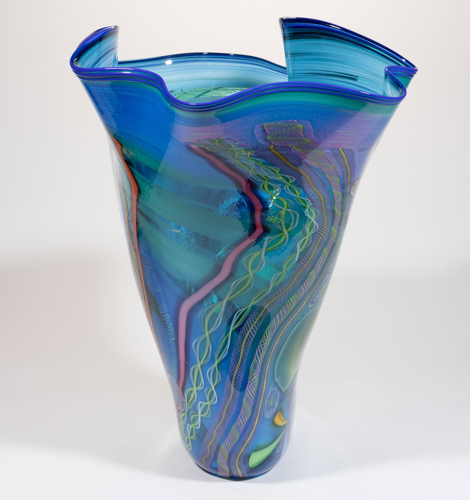 JAMES NOWAK (AMERICAN, B. 1956) MILLEFIORI AND TWIST STUDIO ART GLASS VASE: JAMES NOWAK (AMERICAN, B. 1956) MILLEFIORI AND TWIST STUDIO ART GLASS VASE, blue with opal interior swirling and iridescent decoration, having many large millefiori canes in various colors w