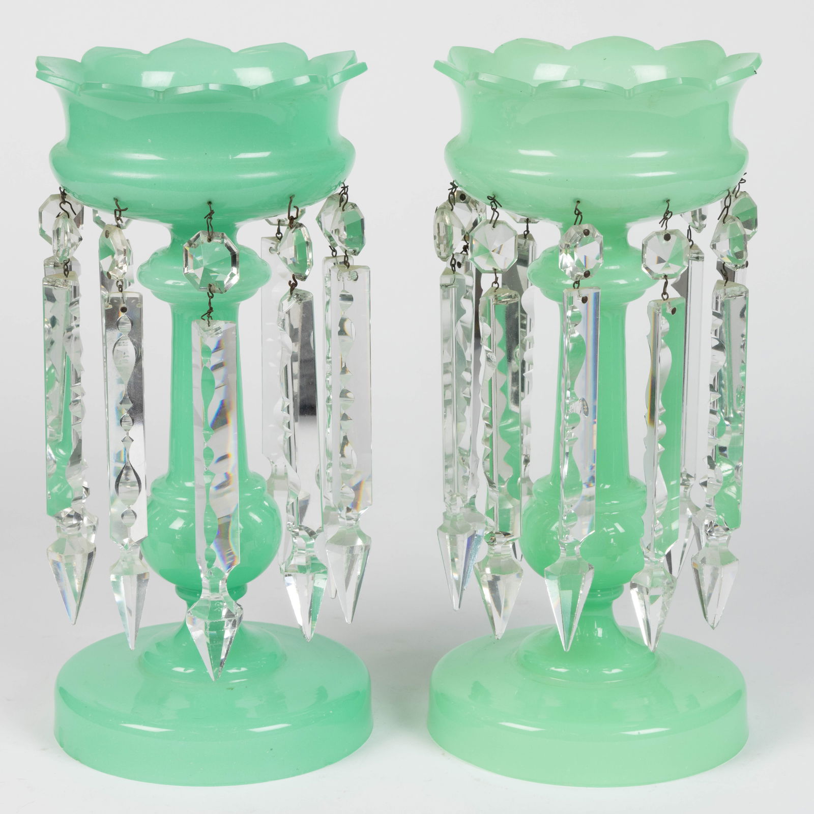 PAIR OF VICTORIAN OPALINE GLASS MANTLE LUSTERS: PAIR OF VICTORIAN OPALINE GLASS MANTLE LUSTERS, opaque pale green/opaline (reacts under black light), compressed urn-form bowl with the rim having ten pointed scallops, raised on a cylindrical st
