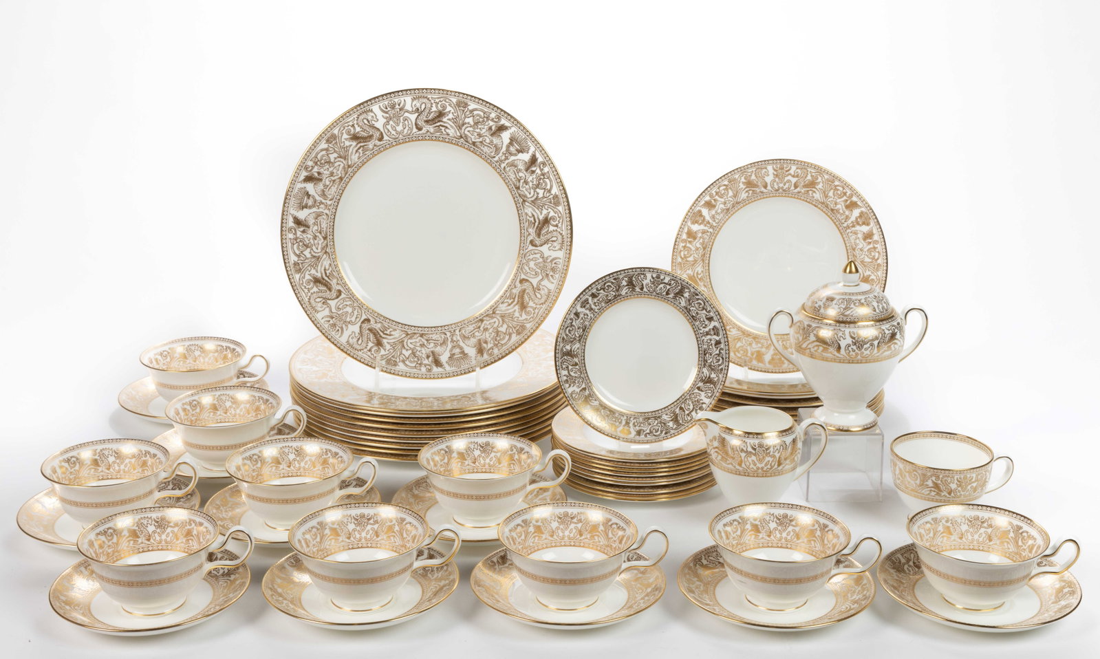 ENGLISH WEDGWOOD PORCELAIN GOLD FLORENTINE 53-PIECE TABLE SET: ENGLISH WEDGWOOD PORCELAIN GOLD FLORENTINE 53-PIECE TABLE SET, each having gilt border design featuring dragons and phoenix birds with scrolls and urns, comprising ten 6" D plates, ten 8&quo