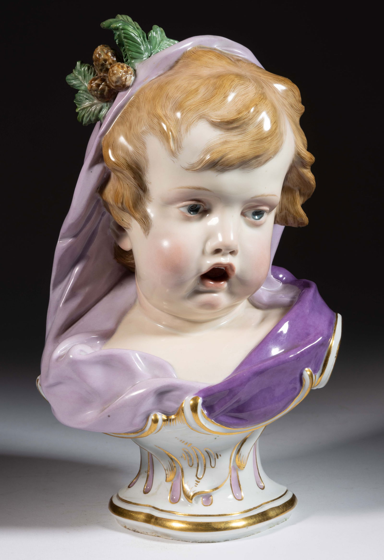 GERMAN MEISSEN PORCELAIN ALLEGORICAL WINTER BUST: GERMAN MEISSEN PORCELAIN ALLEGORICAL WINTER BUST, on a pedestal base, polychrome hand-painted depicting a child wearing a purple head scarf with pine boughs and cones to top. Underglaze