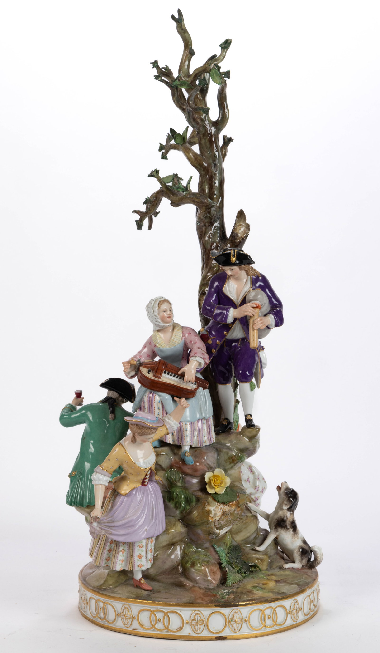 GERMAN MEISSEN PORCELAIN FIGURAL GROUP: GERMAN MEISSEN PORCELAIN FIGURAL GROUP, on a circular base, having polychrome hand-painted decorations featuring five figures and a dog around a central stepped rock with a tall tree including on