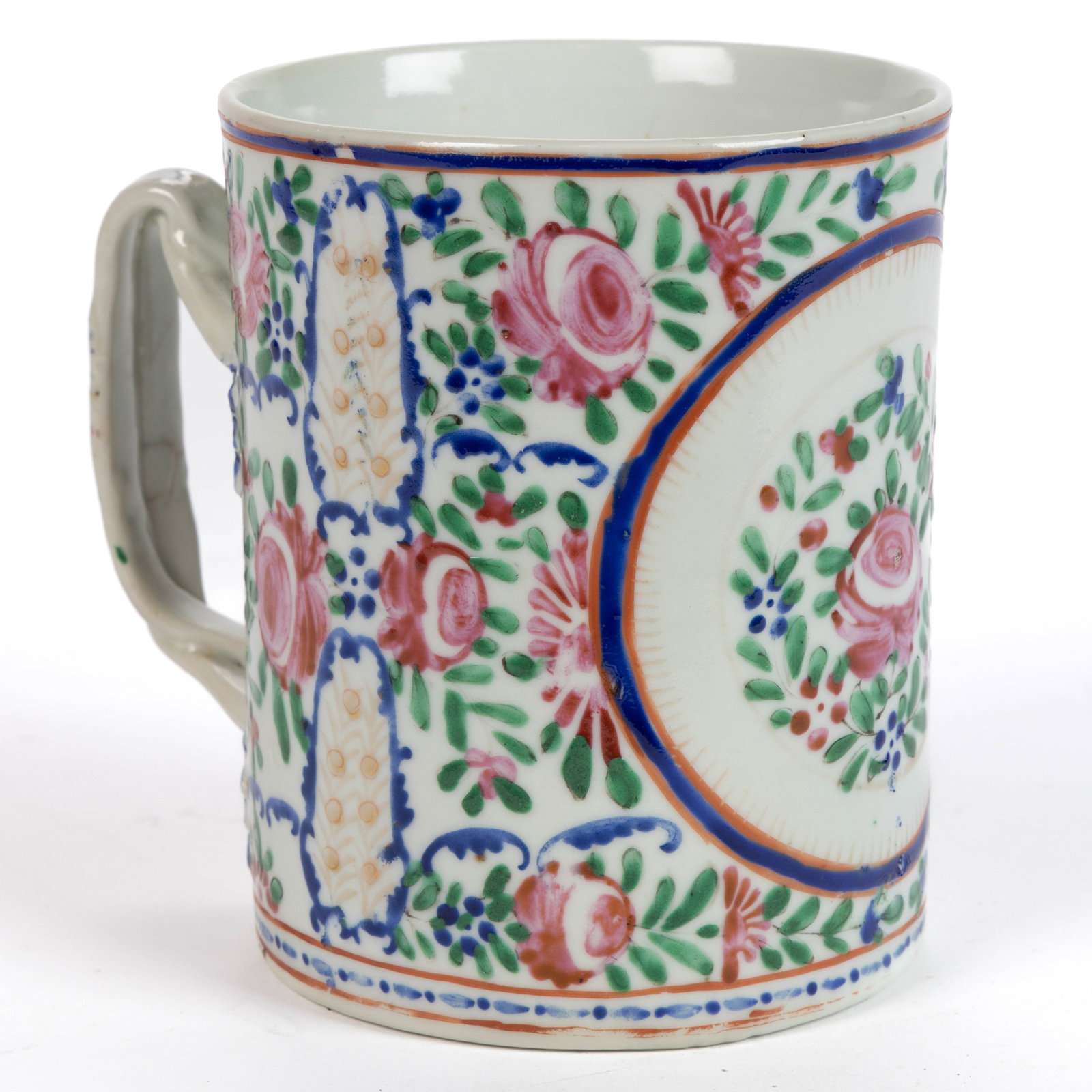 CHINESE EXPORT PORCELAIN FAMILLE ROSE MUG: CHINESE EXPORT PORCELAIN FAMILLE ROSE MUG, cylindrical form with double entwined handles with molded blue-painted foliate terminals, featuring polychrome enamel floral decorations. Late 18th cent