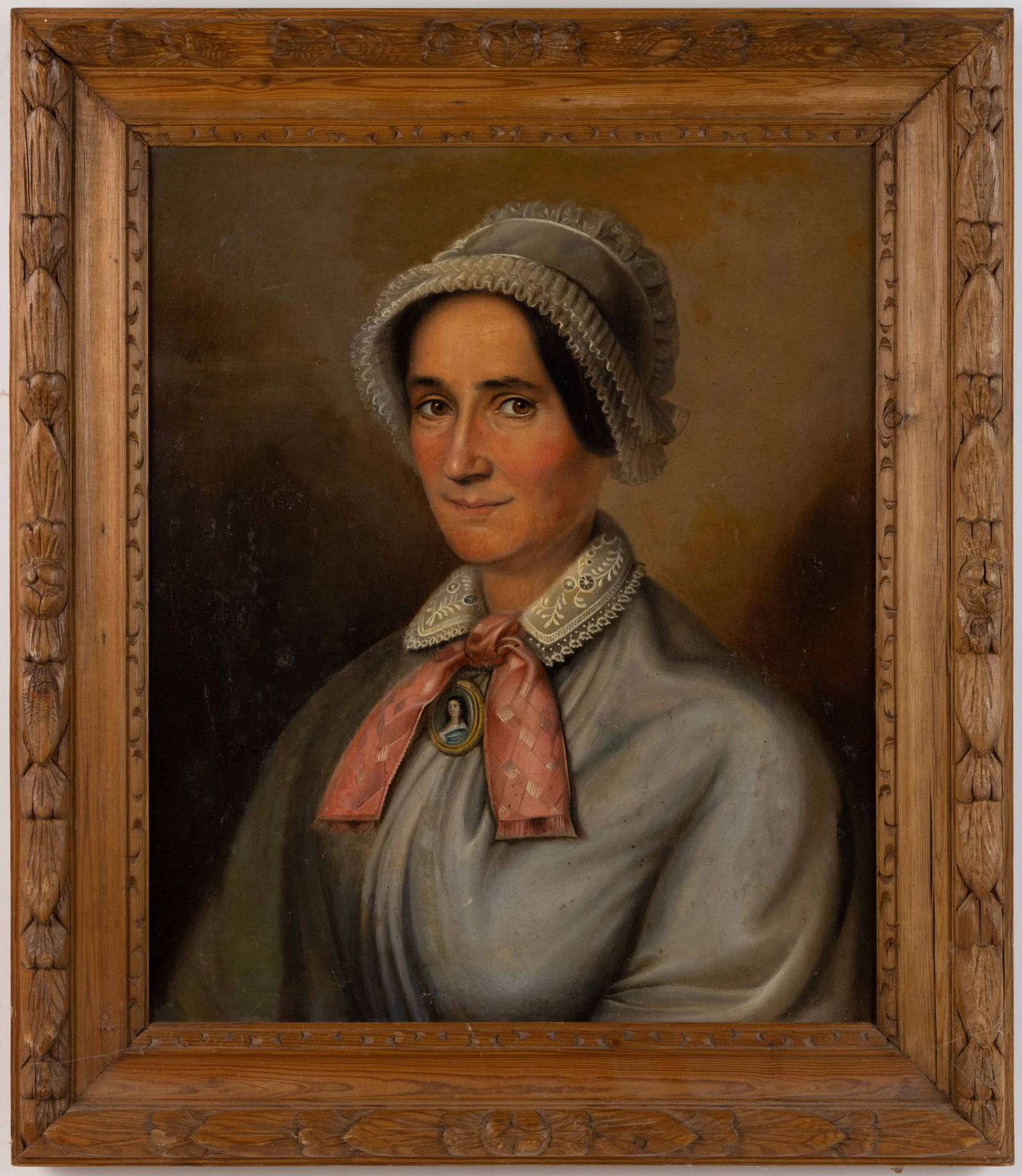 CONTINENTAL SCHOOL (19TH CENTURY) PORTRAIT OF A LADY: CONTINENTAL SCHOOL (19TH CENTURY) PORTRAIT OF A LADY, oil on canvas, featuring a middle aged woman wearing a bonnet and dress with a lace collar, around her neck she wears a miniature portrait of