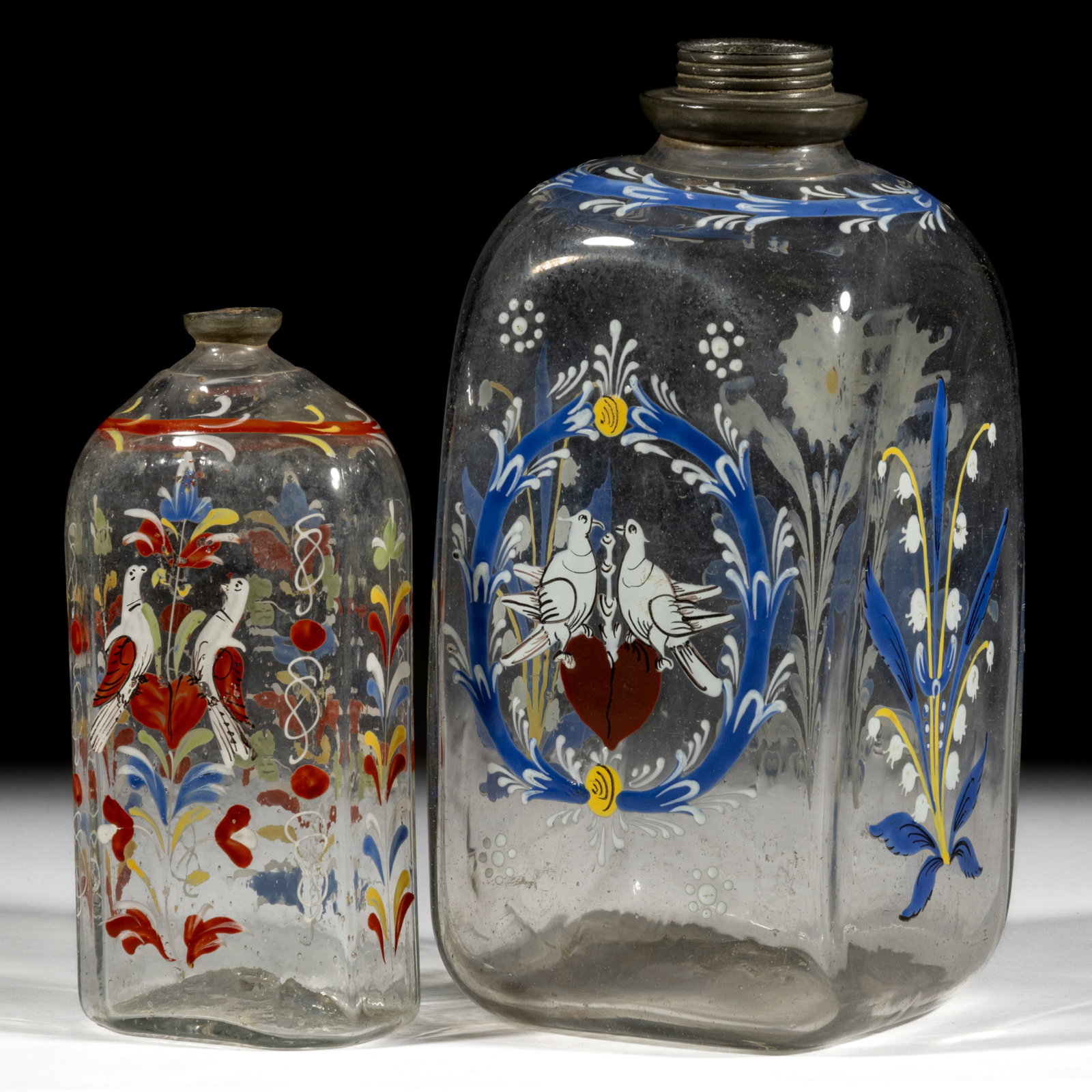 HALF-POST BLOWN AND DECORATED "STIEGEL-TYPE" BOTTLES / FLASKS, LOT OF TWO: HALF-POST BLOWN AND DECORATED "STIEGEL-TYPE" BOTTLES / FLASKS, LOT OF TWO, colorless glass, half-post method, one square so-called "case bottle" and the other of typical flattened 