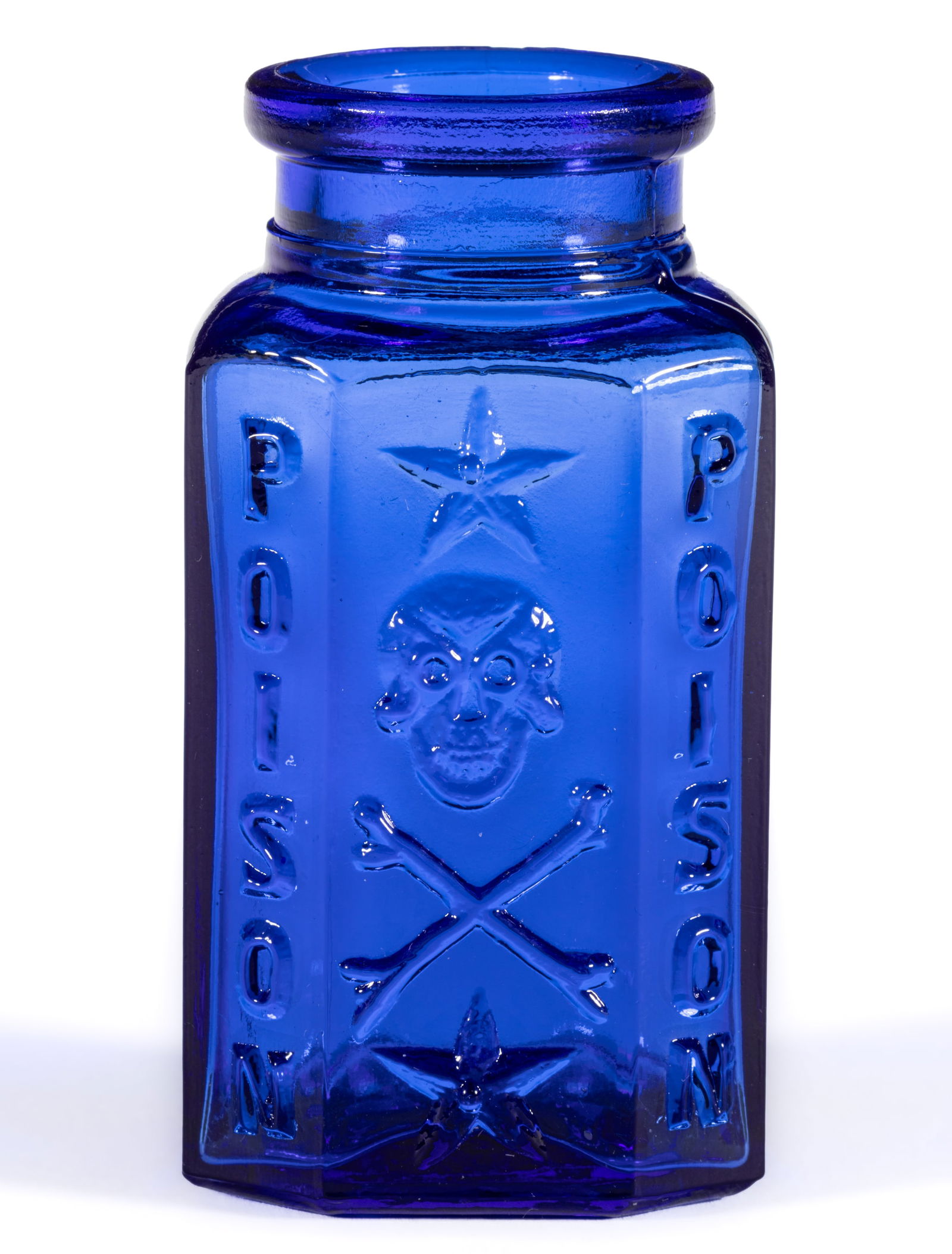SKULL AND CROSSBONES EMBOSSED KU-19 POISON BOTTLE: SKULL AND CROSSBONES EMBOSSED KU-19 POISON BOTTLE, cobalt blue, irregular shape with rounded back and three flat panels, strongly embossed with pictorial so-called "laughing" skull and
