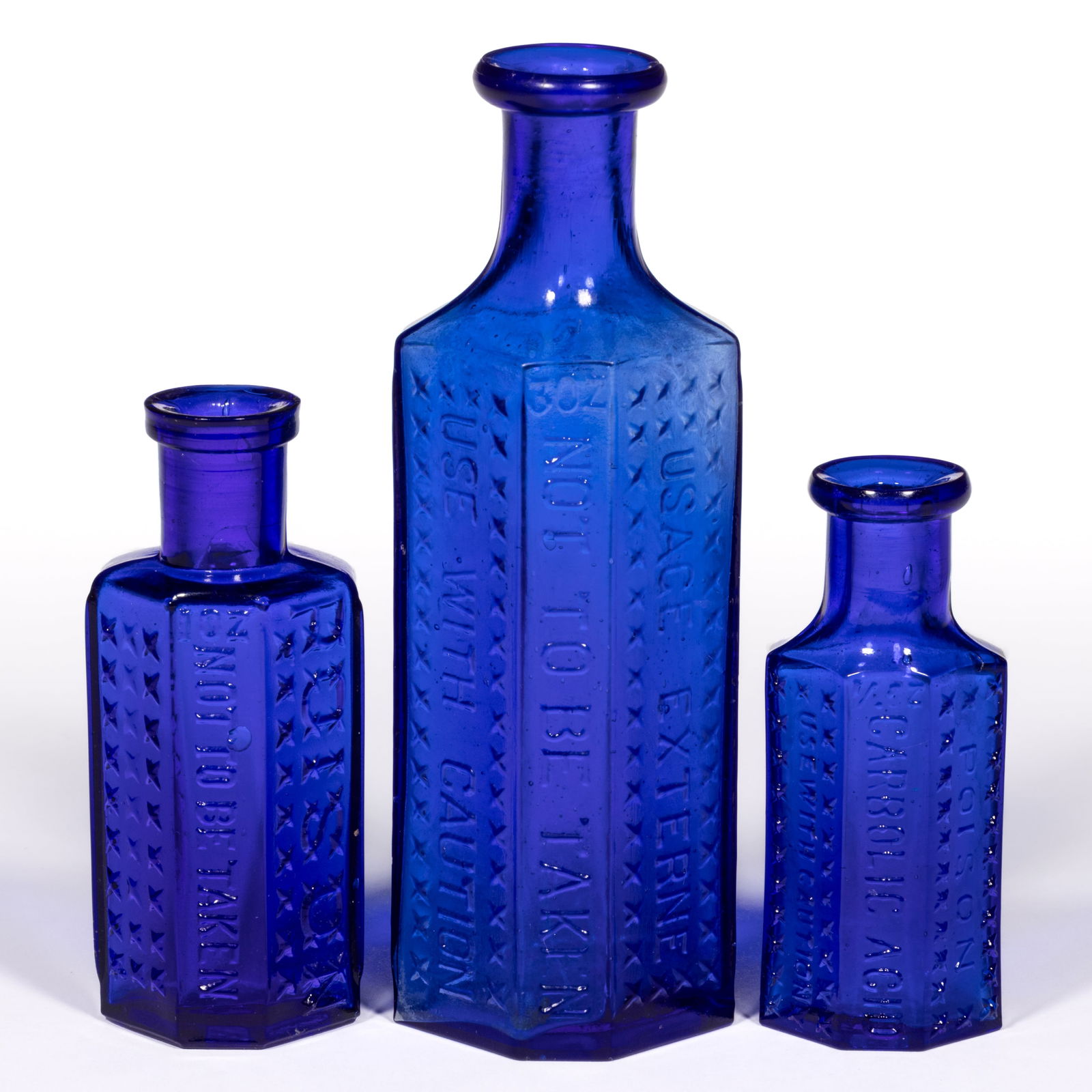 CANADIAN FLAT BACK / IRREGULAR HEXAGONAL-FORM POISON BOTTLES, LOT OF THREE: CANADIAN FLAT BACK / IRREGULAR HEXAGONAL-FORM POISON BOTTLES, LOT OF THREE, cobalt blue, flat backs with three angled front panels having pointed diamond patterning, comprising a 1/2oz KI-4 embos