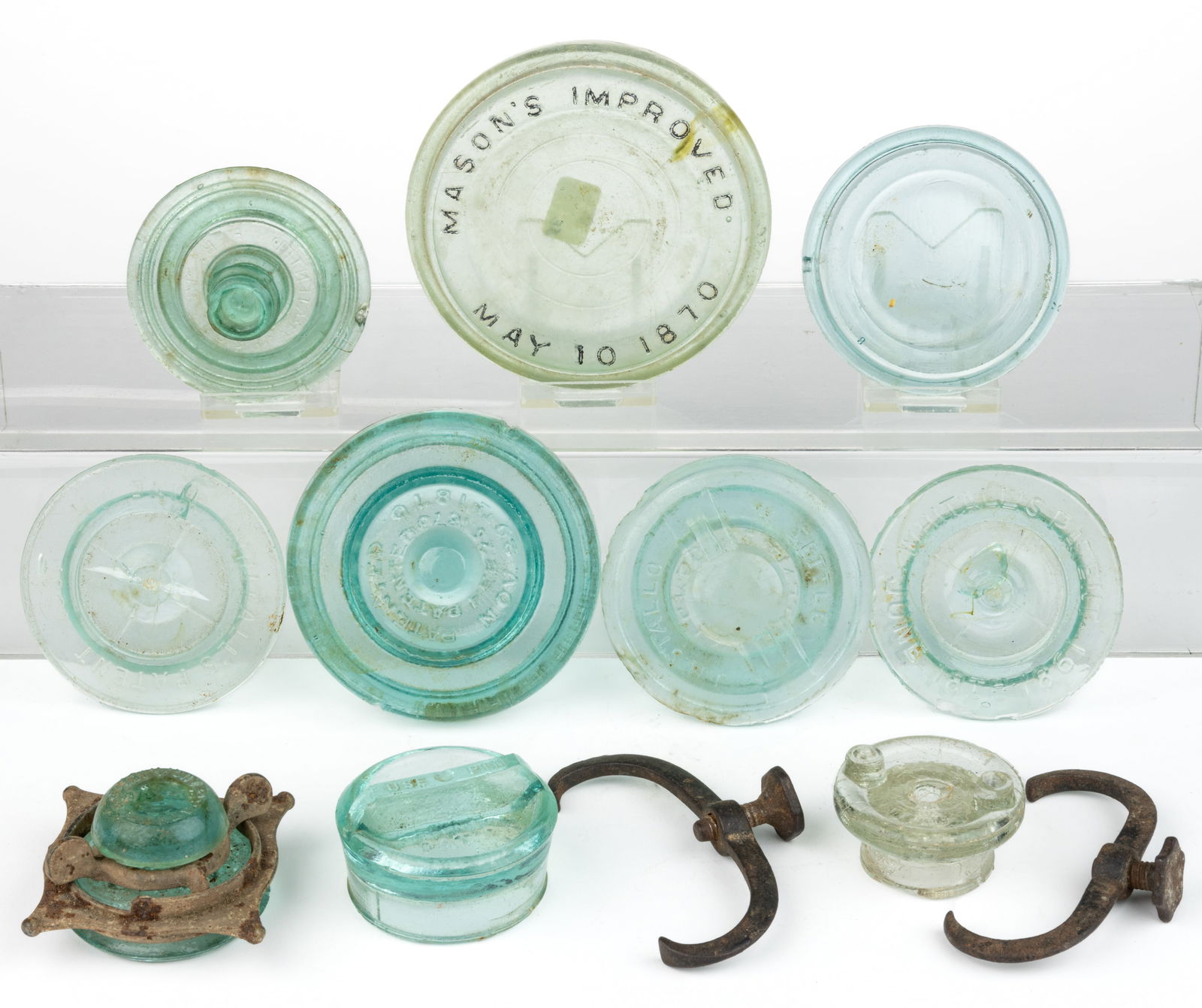 ASSORTED ANTIQUE FRUIT JAR CLOSURES AND LIDS / INSERTS, UNCOUNTED LOT: ASSORTED ANTIQUE FRUIT JAR CLOSURES AND LIDS / INSERTS, UNCOUNTED LOT, mostly aqua glass and some metal/cast-iron components, including a pair of lids and thumbscrew clamps for Whitall's Patent Mi