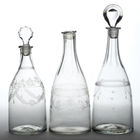 FREE-BLOWN AND ENGRAVED GLASS DECANTERS, LOT OF THREE