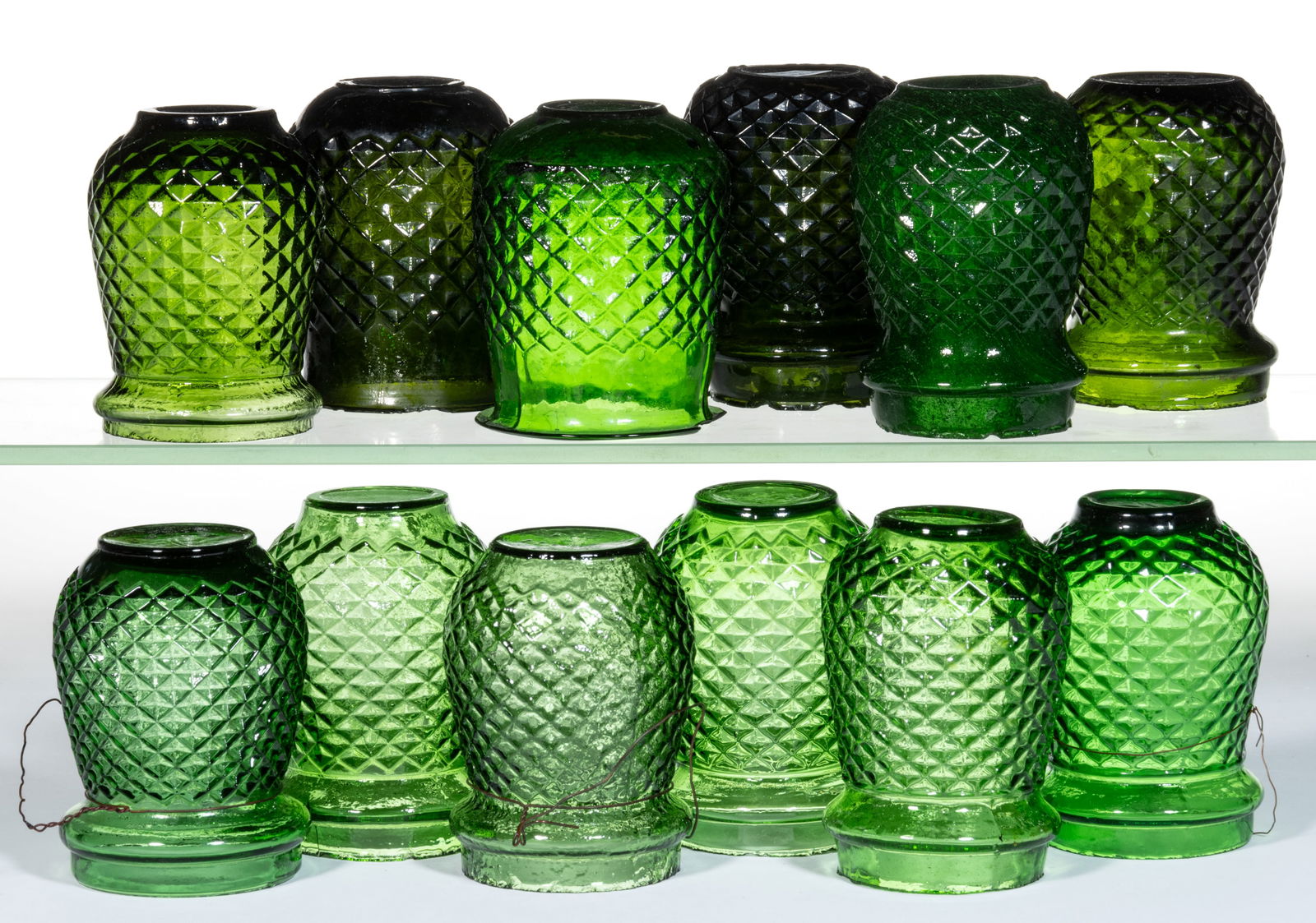 DIAMOND-PATTERN MOLDED GLASS CHRISTMAS LIGHTS, LOT OF 12: DIAMOND-PATTERN MOLDED GLASS CHRISTMAS LIGHTS, LOT OF 12, varying shades of green. Fourth quarter 19th/first quarter 20th century. 3 5/8" to 3 3/4" H. 