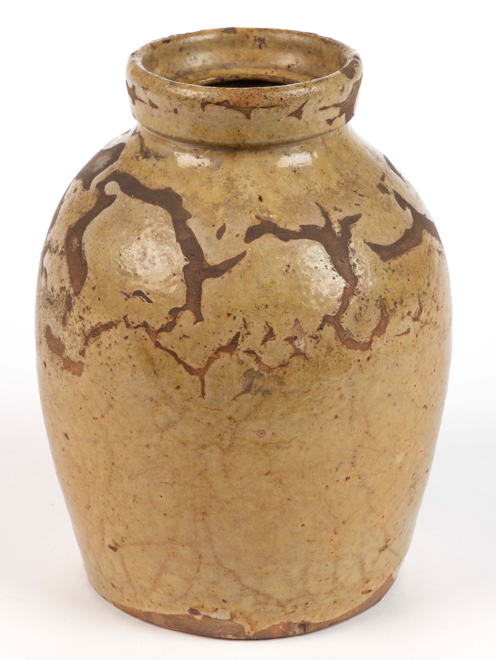 NEW ENGLAND EARTHENWARE / REDWARE STORAGE JAR: NEW ENGLAND EARTHENWARE / REDWARE STORAGE JAR, lead-glazed with a cream-colored slip having mottled/vein-like crawling to surface, approximately one-quart capacity, ovoid body with rounded should