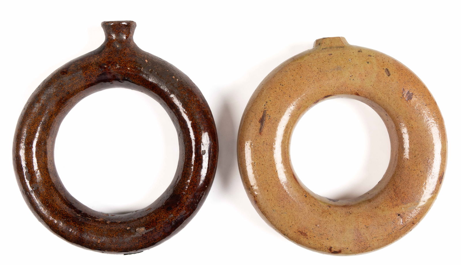 AMERICAN EARTHENWARE / REDWARE RING BOTTLES / FLASKS, LOT OF TWO: AMERICAN EARTHENWARE / REDWARE RING BOTTLES / FLASKS, LOT OF TWO, lead-glazed, comprising one having additional slip wash with octagonal mouth and remaining with plain mouth. 19th century. 7 1/2&
