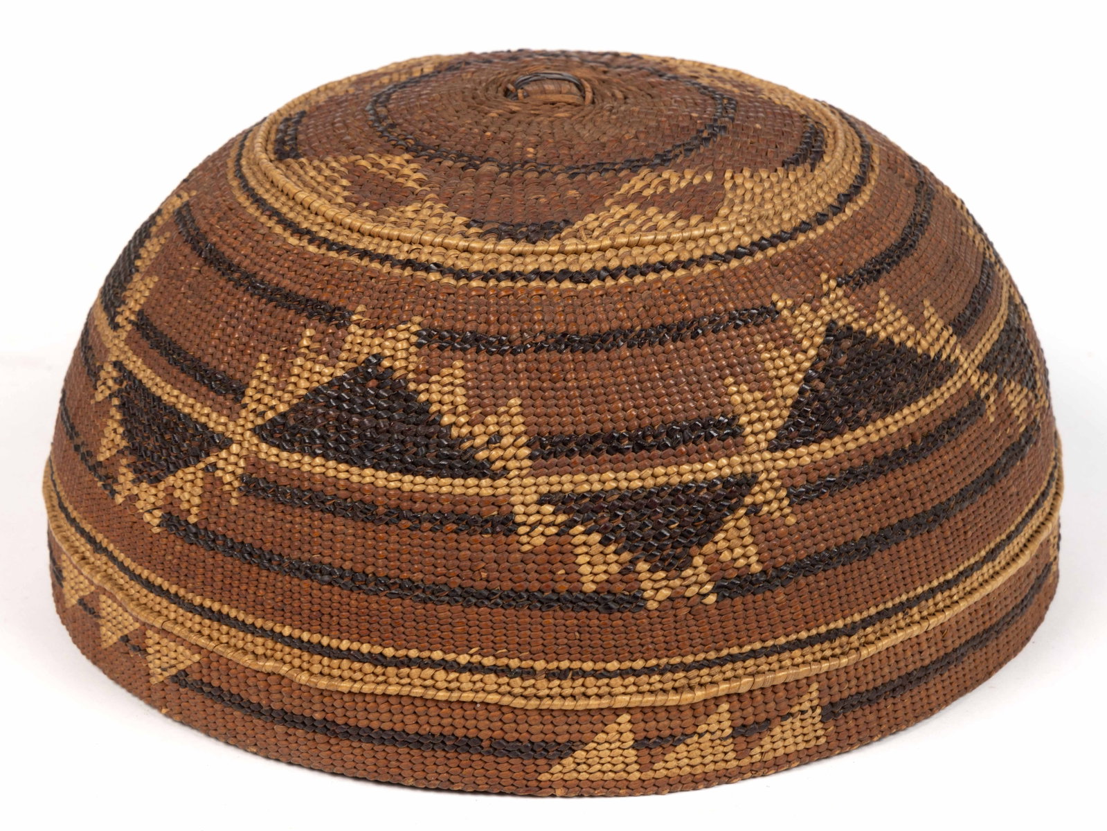 NATIVE AMERICAN HUPA / KARUK / YUROK TWINE-WOVEN BASKET HAT: NATIVE AMERICAN HUPA / KARUK / YUROK TWINE-WOVEN BASKET HAT, round bowl form, geometric designs featuring linear and serrated triangle bands. Northern California. Late 19th/first quarter 20t