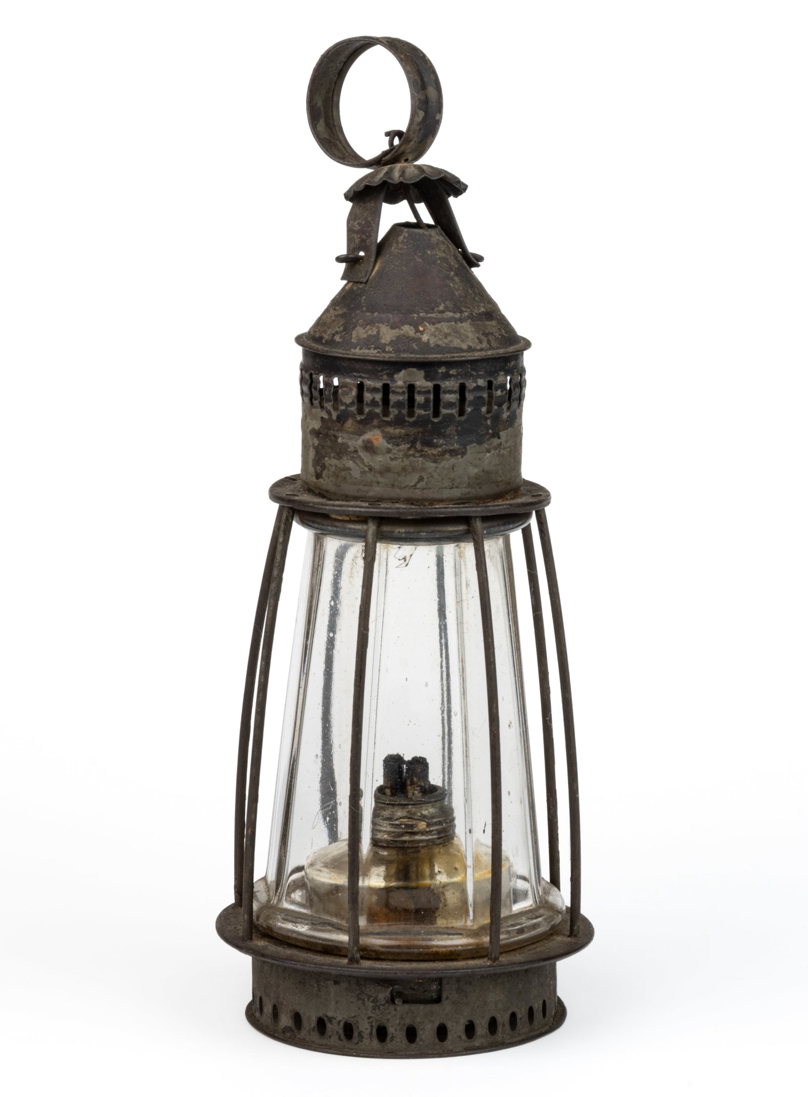 PIERCED AND PUNCHED SHEET-IRON / TIN WHALE OIL LANTERN: PIERCED AND PUNCHED SHEET-IRON / TIN WHALE OIL LANTERN, colorless fixed blown-molded eight-paneled tapered-form globe within a wire guard, conical form cap with punched slits, small strap-ring ha