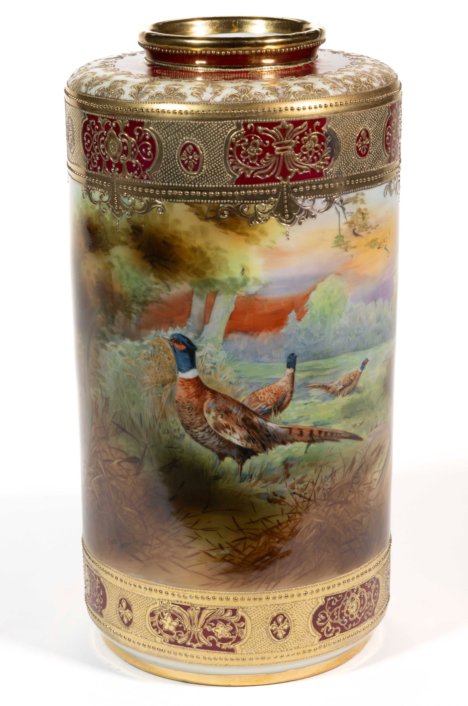 JAPANESE NIPPON PORCELAIN GAME BIRD MOTIF LARGE VASE: JAPANESE NIPPON PORCELAIN GAME BIRD MOTIF LARGE VASE, cylindrical form, having polychrome hand-painted scene featuring three colorful pheasants in a field bordered by trees with raised gilt and beaded