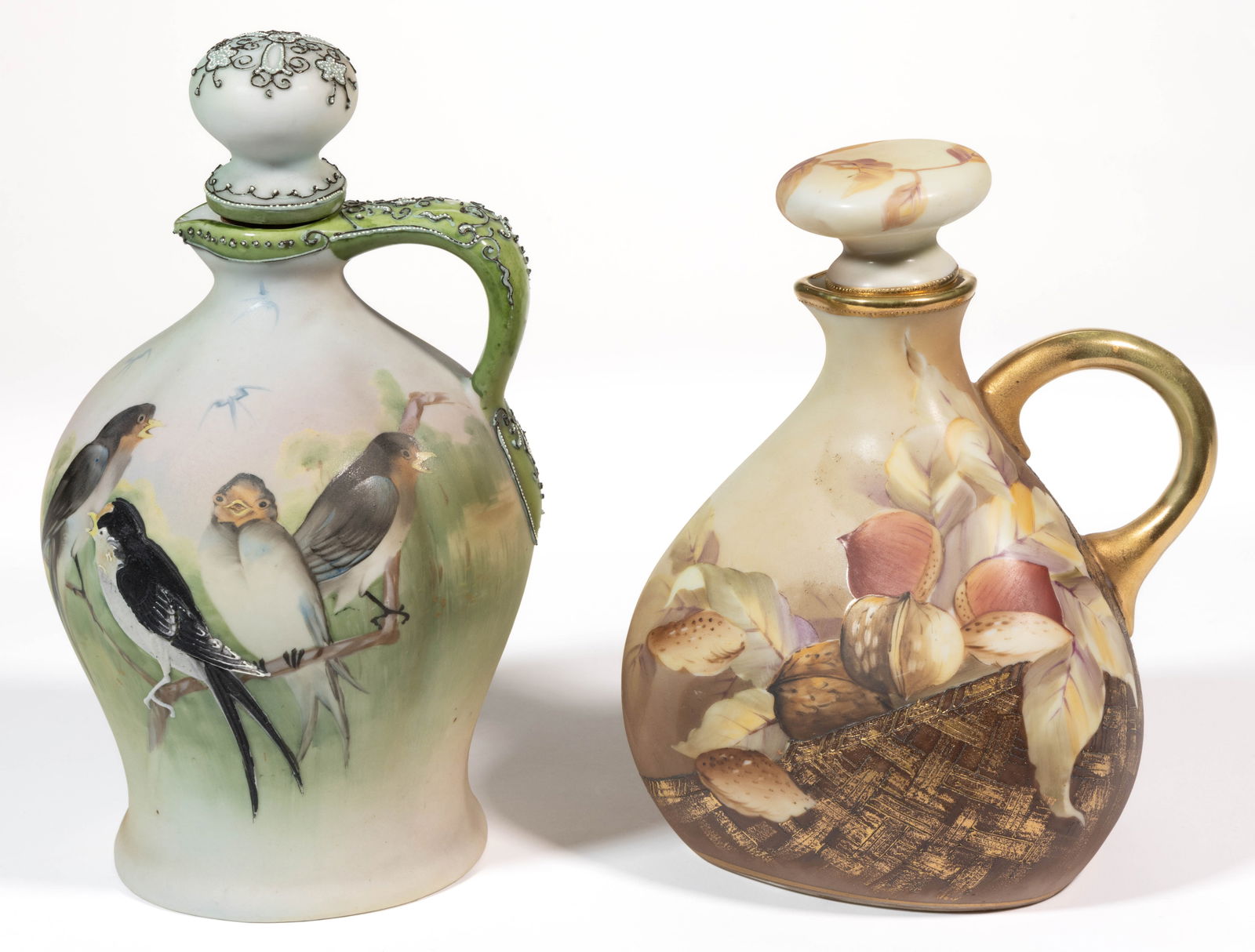 JAPANESE NIPPON PORCELAIN MORIAGE WINE JUGS, LOT OF TWO: JAPANESE NIPPON PORCELAIN MORIAGE WINE JUGS, LOT OF TWO, each having polychrome hand-painted images with stopper to top, comprising one example featuring four small birds perched to a branch including