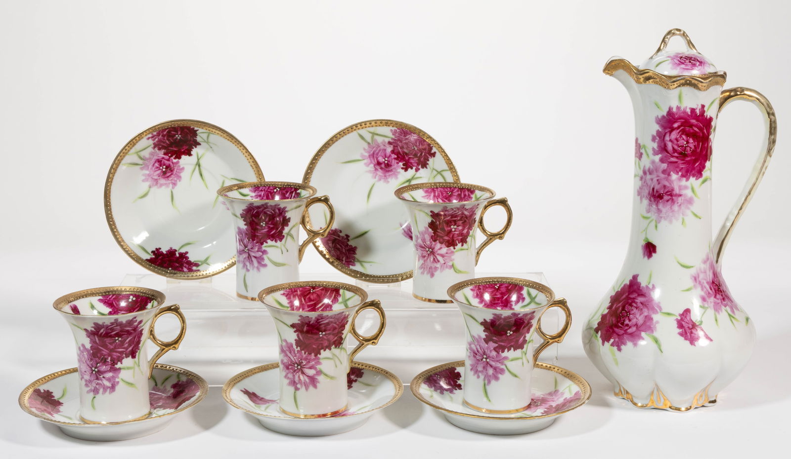 JAPANESE ROYAL KINRAN NIPPON PORCELAIN 11-PIECE CHOCOLATE SET: JAPANESE ROYAL KINRAN NIPPON PORCELAIN 11-PIECE CHOCOLATE SET, each having bright polychrome hand-painted floral designs with gilt rim and handles, comprising a chocolate pot and five cup and saucer s