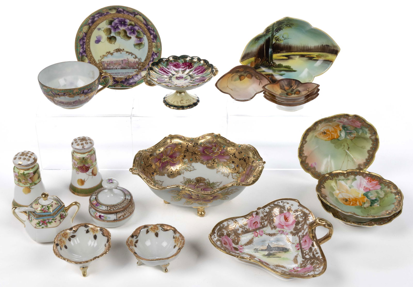 JAPANESE NIPPON PORCELAIN HAND-PAINTED ARTICLES, LOT OF 18: JAPANESE NIPPON PORCELAIN HAND-PAINTED ARTICLES, LOT OF 18, including a four-footed dish with flower, gilt overlay and polychrome enamelled jewel decorations, two souvenir examples including a triangu