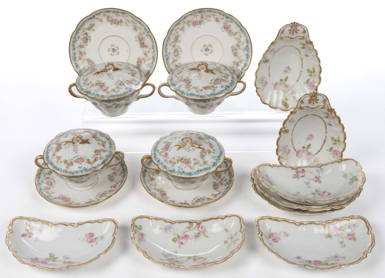 FRENCH LIMOGES PORCELAIN TABLE ARTICLES, LOT OF 16: FRENCH LIMOGES PORCELAIN TABLE ARTICLES, LOT OF 16, each featuring polychrome transfer floral designs with gilt decorations, comprising four covered bouillon bowl and saucer sets featuring rose swags 