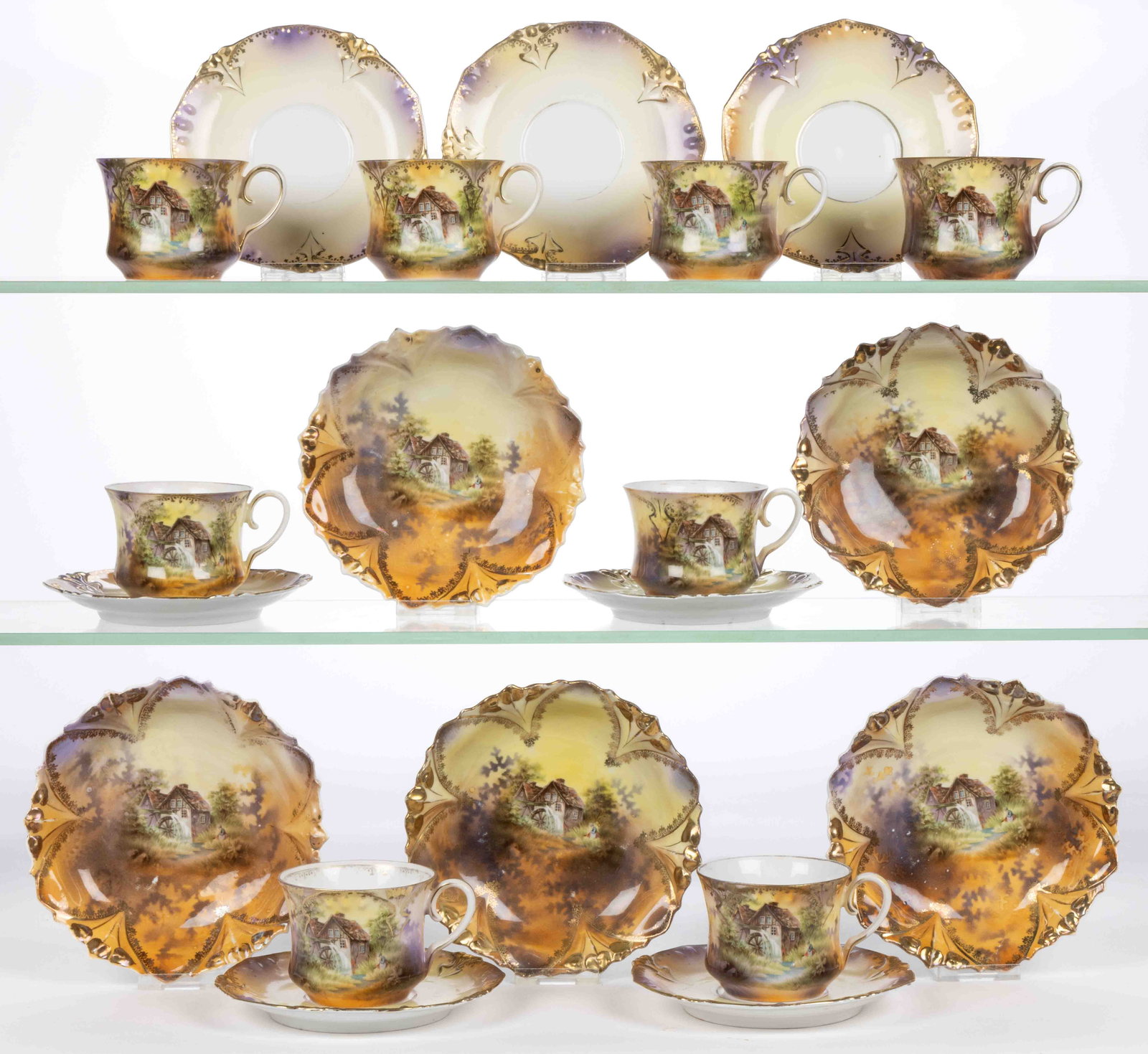 R.S. PRUSSIA PORCELAIN MILL SCENIC MOTIF TEA AND TABLE ARTICLES, LOT OF 20: R.S. PRUSSIA PORCELAIN MILL SCENIC MOTIF TEA AND TABLE ARTICLES, LOT OF 20, RSP Mold 98, each having polychrome transfer scene depicting a charming mill with waterwheel and a woman sitting in tall gra