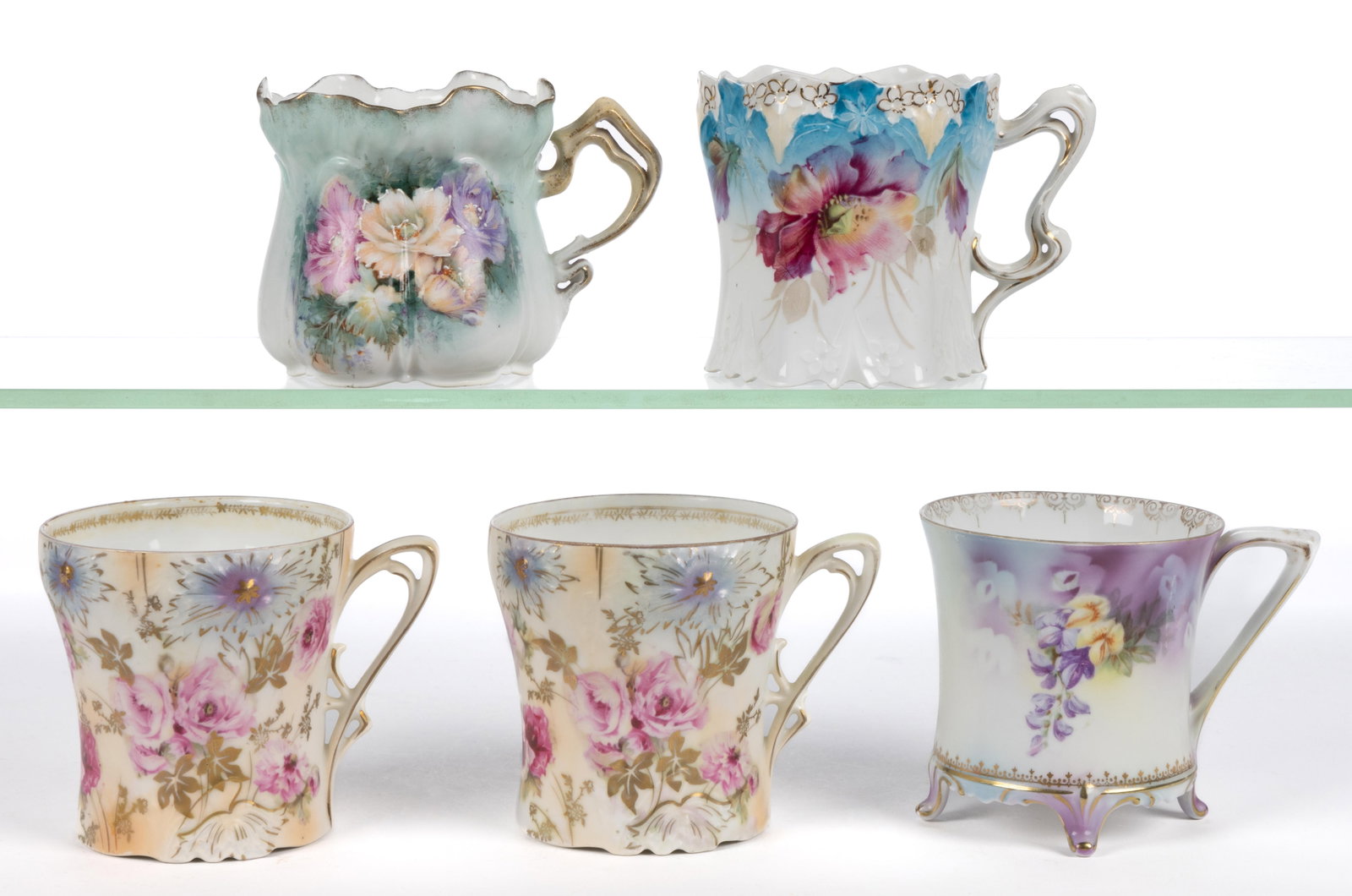 R.S. PRUSSIA / GERMANY PORCELAIN FLORAL MOTIF MUGS, LOT OF FIVE: R.S. PRUSSIA / GERMANY PORCELAIN FLORAL MOTIF MUGS, LOT OF FIVE, each having polychrome transfer designs with gilt accents, comprising one RSP Mold 502 example having additional white hand-painted acc