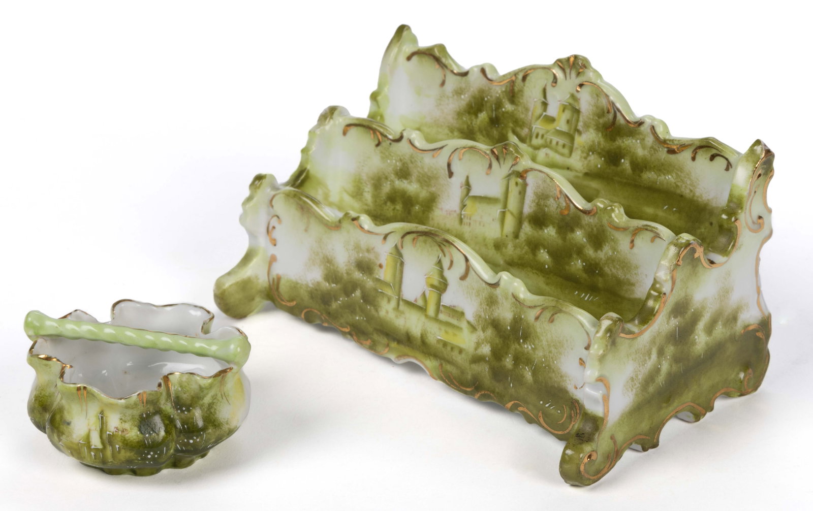 R.S. PRUSSIA PORCELAIN HAND-PAINTED CASTLE MOTIF ARTICLES, LOT OF TWO: R.S. PRUSSIA PORCELAIN HAND-PAINTED CASTLE MOTIF ARTICLES, LOT OF TWO, each featuring a green castle-like structure nestled between trees with gilt accents, comprising a Mold OM 20 letter holder/organ