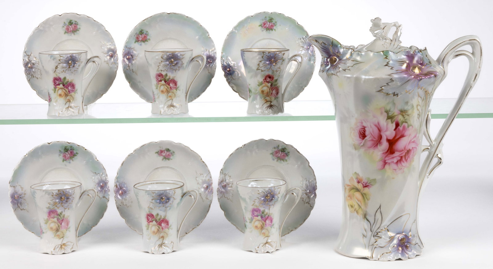 R.S. PRUSSIA PORCELAIN FLORAL MOTIF 13-PIECE CHOCOLATE SET: R.S. PRUSSIA PORCELAIN FLORAL MOTIF 13-PIECE CHOCOLATE SET, RSP Mold 28, each having molded open lavender flower and polychrome transfer featuring beautiful roses, gilt accents, and satin finish. Many