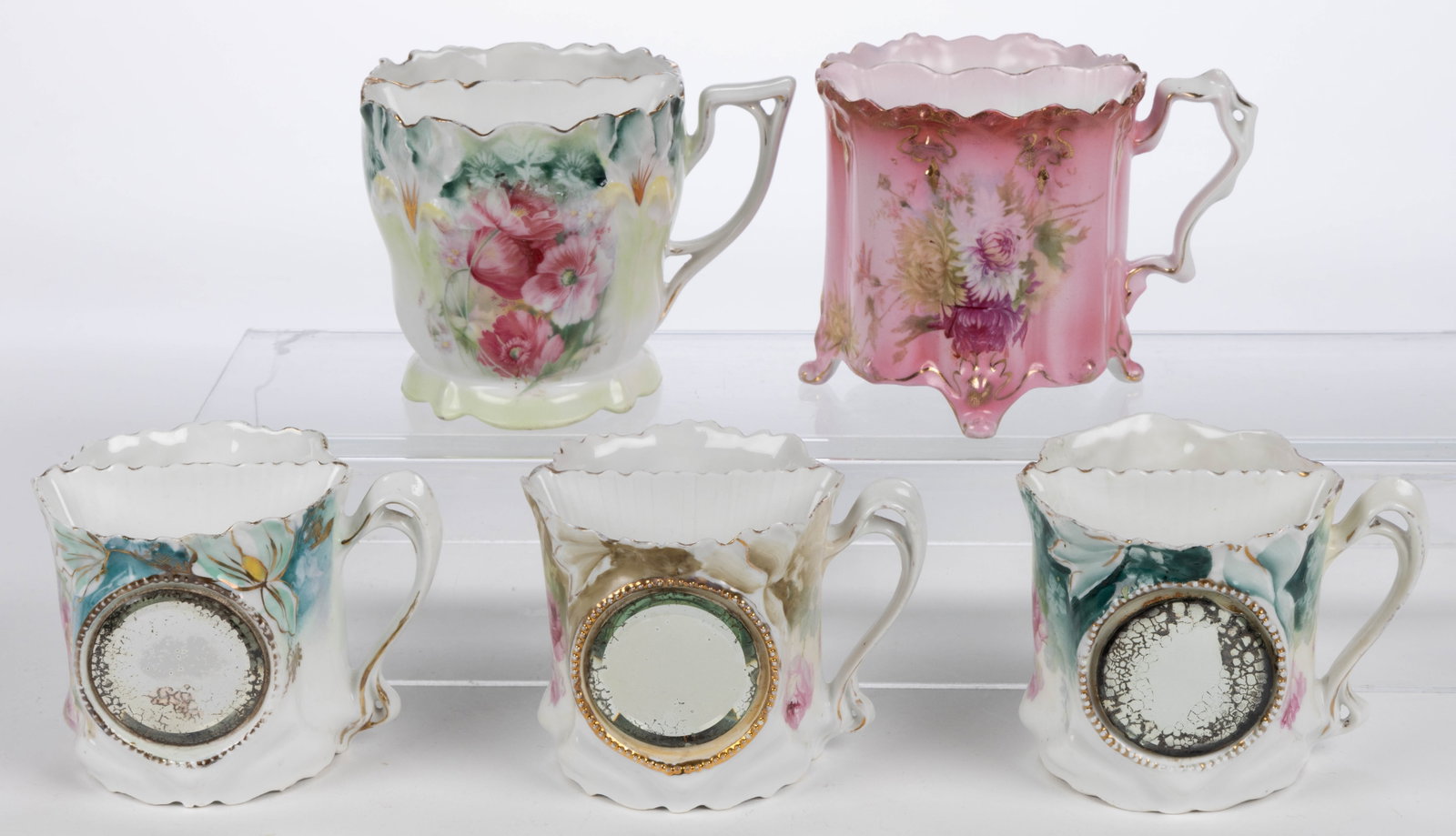 R.S. PRUSSIA / STEEPLE PORCELAIN FLORAL MOTIF SHAVING MUGS, LOT OF FIVE: R.S. PRUSSIA / STEEPLE PORCELAIN FLORAL MOTIF SHAVING MUGS, LOT OF FIVE, each having colorful polychrome transfer flower designs, comprising one RSP Mold 25 example, one Mold RS 33 four-footed example