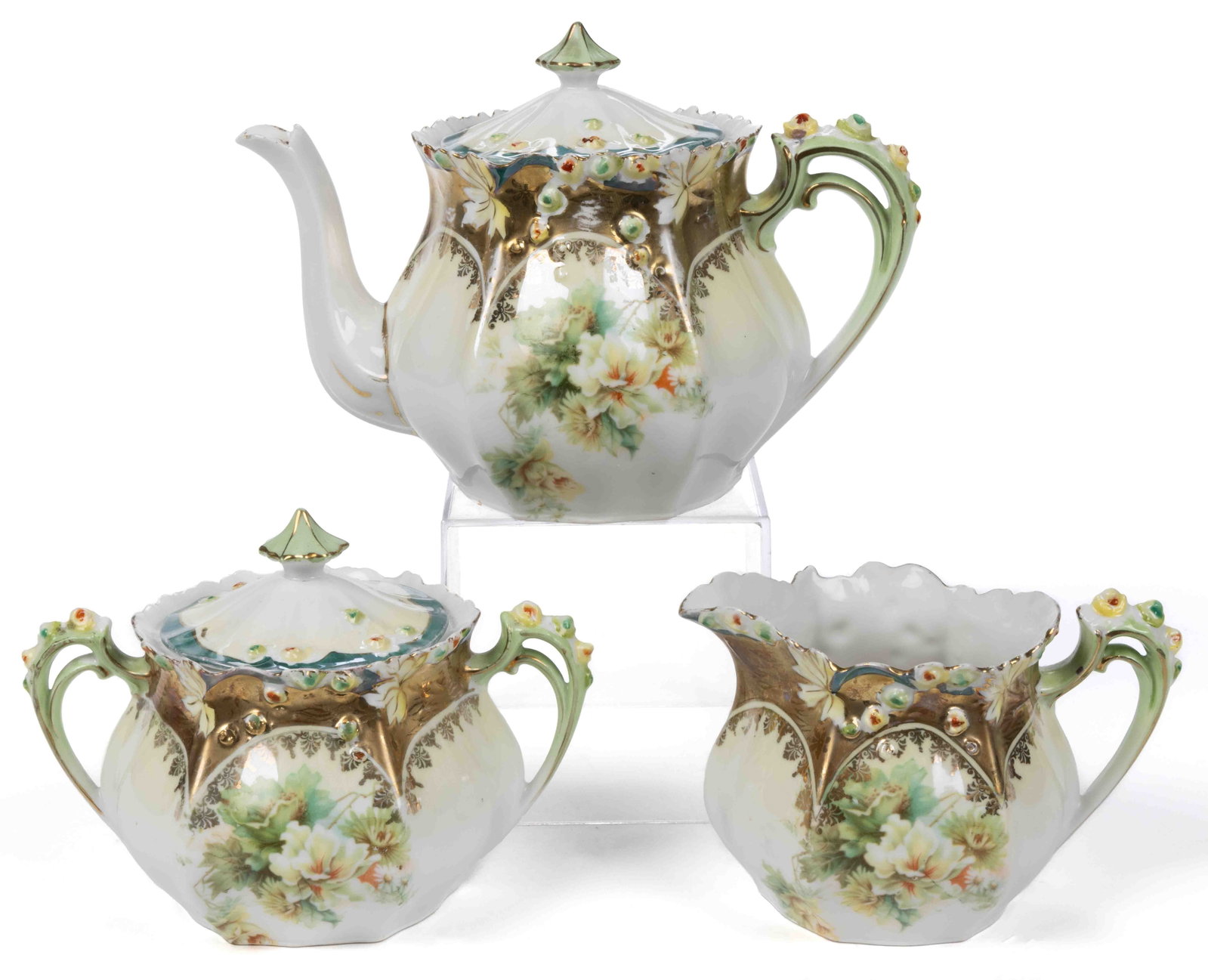 R.S. GERMANY PORCELAIN FLORAL MOTIF THREE-PIECE TEA SET: R.S. GERMANY PORCELAIN FLORAL MOTIF THREE-PIECE TEA SET, RS Steeple Mold 7, each having polychrome transfer featuring various flowers, embossed hand-painted buds and leaves to handles and rims. Each h