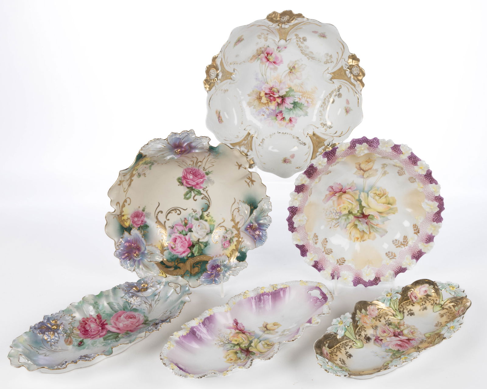 R.S. PRUSSIA PORCELAIN FLORAL MOTIF TABLE ARTICLES, LOT OF SIX: R.S. PRUSSIA PORCELAIN FLORAL MOTIF TABLE ARTICLES, LOT OF SIX, all having polychrome transfer floral motif featuring three different molds, each consisting of an open-handled celery tray and bowl, co