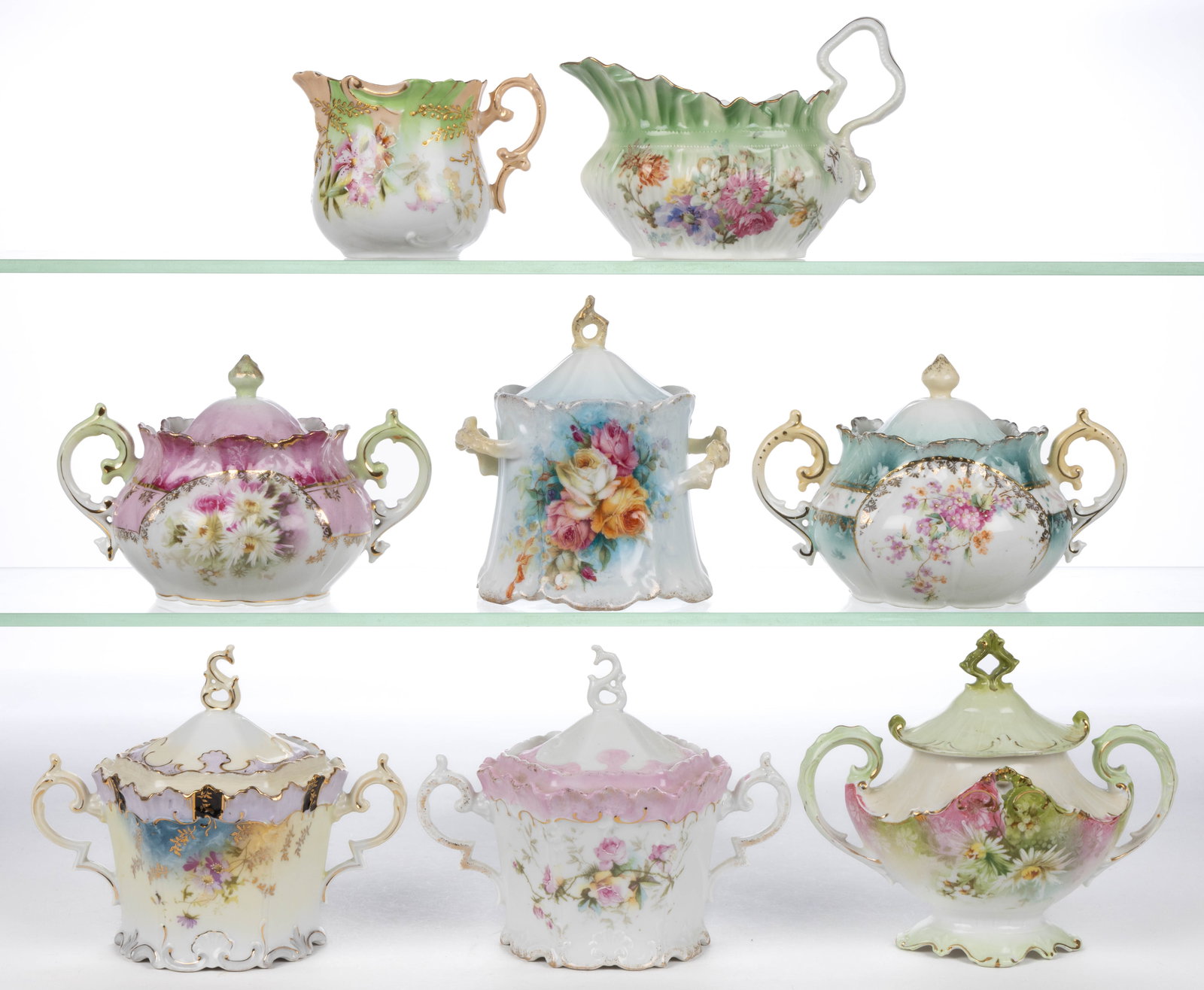 EARLY R.S. PRUSSIA PORCELAIN FLORAL MOTIF TEA AND TABLE ARTICLES, LOT OF EIGHT: EARLY R.S. PRUSSIA PORCELAIN FLORAL MOTIF TEA AND TABLES ARTICLES, LOT OF EIGHT, each having polychrome flower designs with additional gilt decorations, comprising six covered sugars including two Mol