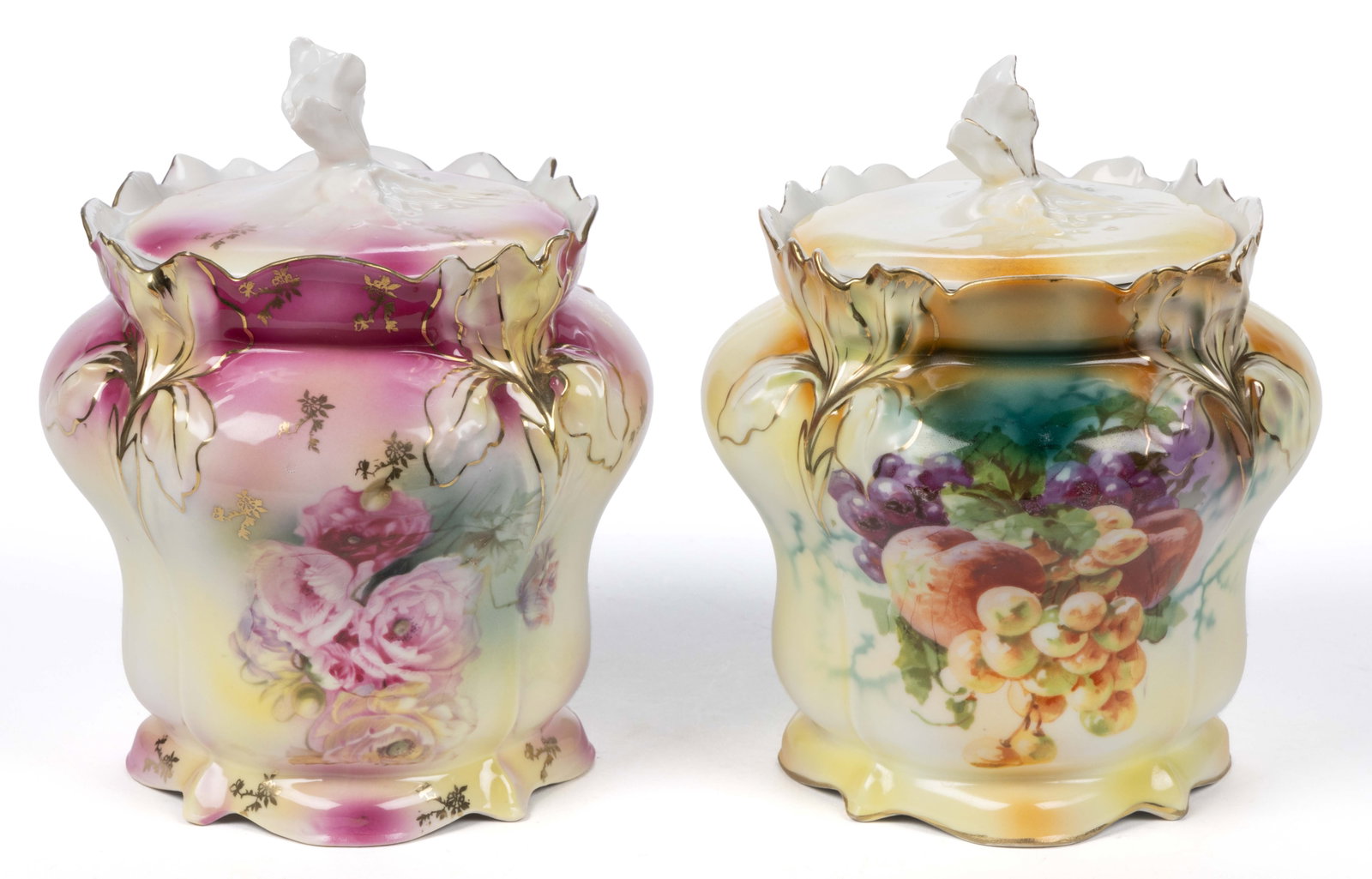 R.S. PRUSSIA PORCELAIN COVERED BISCUIT JARS, LOT OF TWO: R.S. PRUSSIA PORCELAIN COVERED BISCUIT JARS, LOT OF TWO, RSP Mold 25, each having molded iris flower rim and cover with figural flower finial, comprising one example having poppy flower transfer on mo