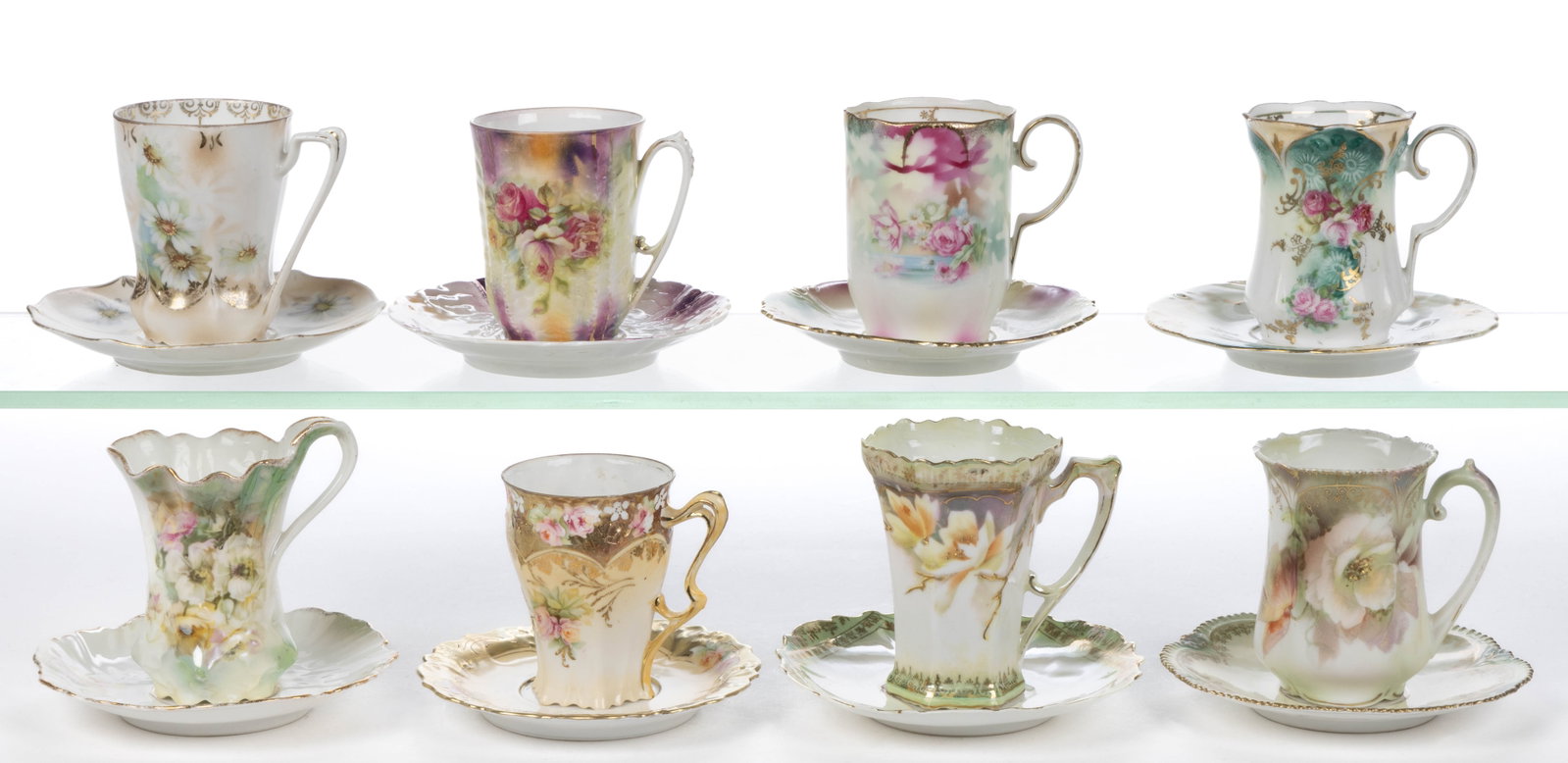 R.S. PRUSSIA PORCELAIN FLORAL MOTIF CHOCOLATE CUP AND SAUCER SETS, LOT OF EIGHT: R.S. PRUSSIA PORCELAIN FLORAL MOTIF CHOCOLATE CUP AND SAUCER SETS, LOT OF EIGHT, each having polychrome transfer decorations, including one possible RS Steeple Mold 10 example having molded flower to 
