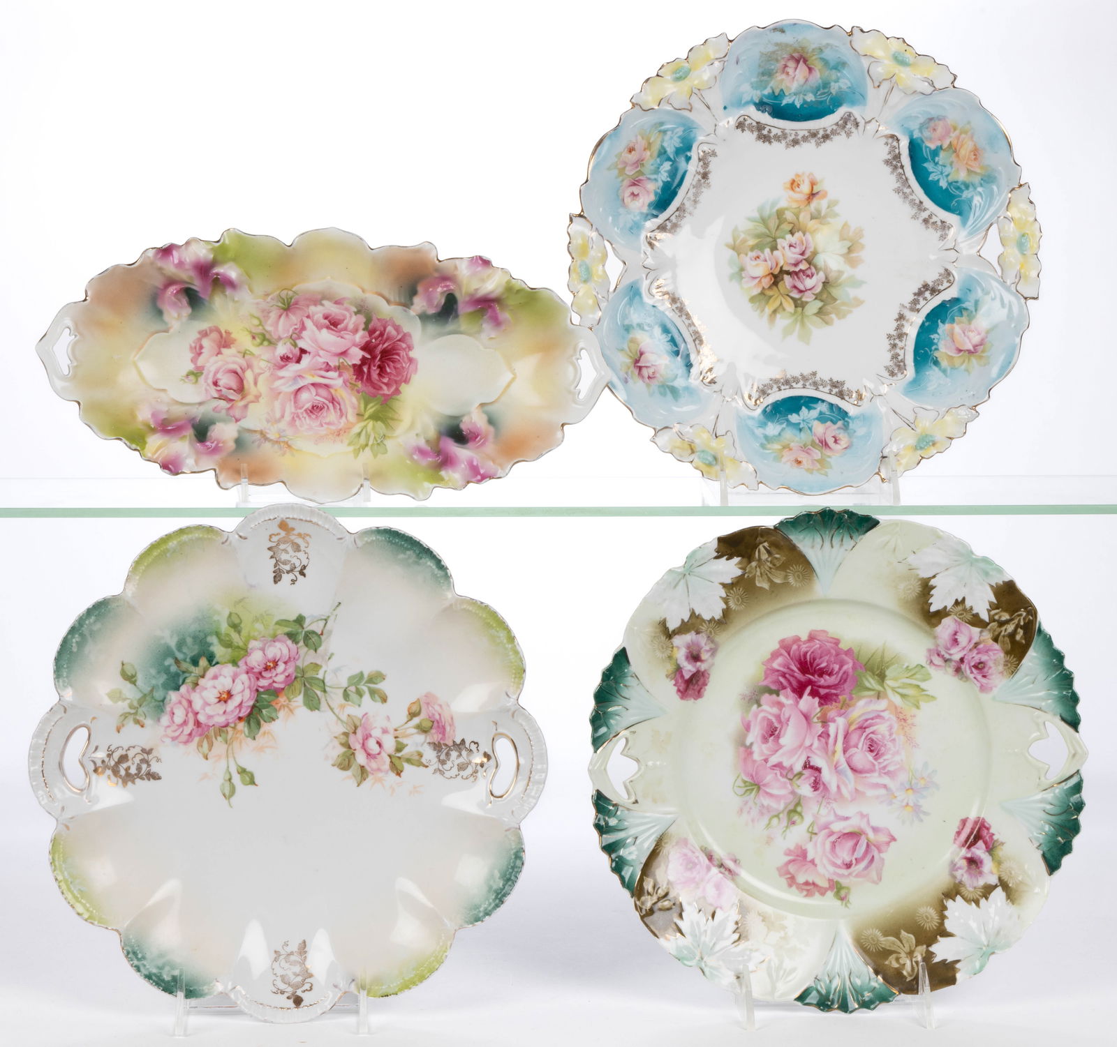 R.S. PRUSSIA PORCELAIN FLORAL MOTIF TABLE ARTICLES, LOT OF FOUR: R.S. PRUSSIA PORCELAIN FLORAL MOTIF TABLE ARTICLES, LOT OF FOUR, each having polychrome transfer rose images, comprising a RSP Mold 25 celery tray with bouquet motif and three cake plates including a