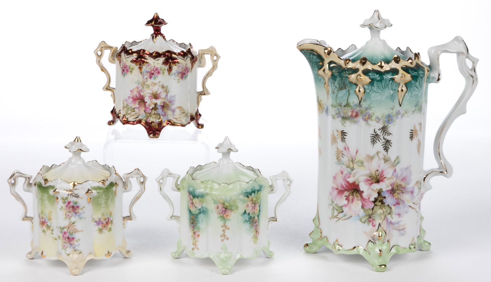 R.S. PRUSSIA PORCELAIN FLORAL MOTIF CHOCOLATE AND TEA ARTICLES, LOT OF FOUR: R.S. PRUSSIA PORCELAIN FLORAL MOTIF CHOCOLATE AND TEA ARTICLES, LOT OF FOUR, Mold RS 33, each of four-footed form featuring polychrome transfer with additional gilt decorations, comprising one chocola