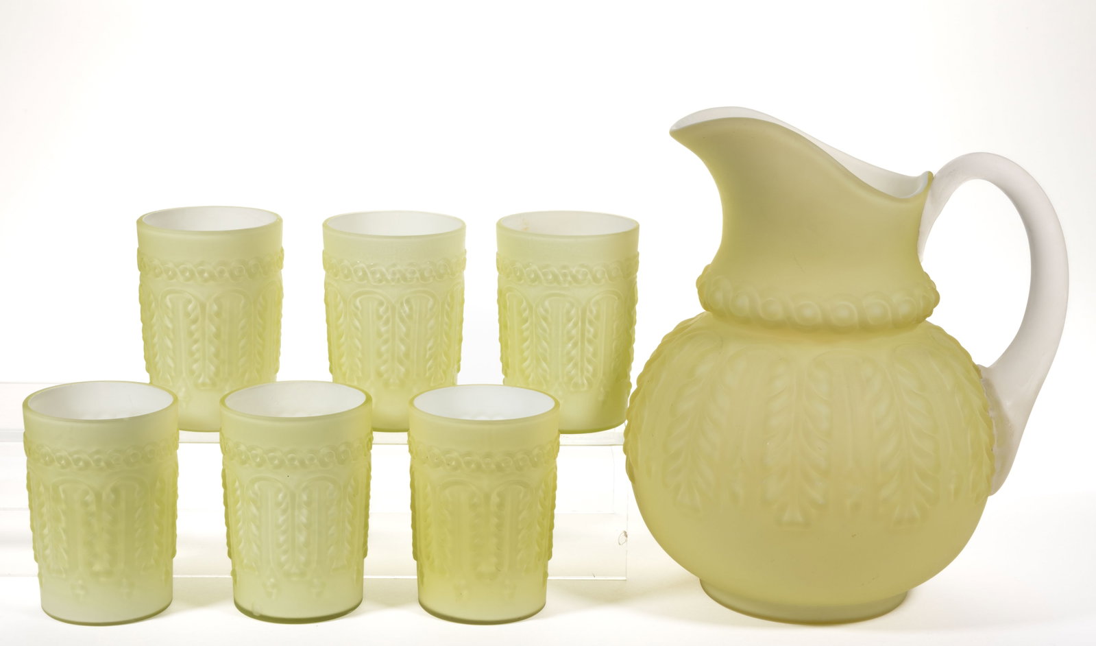 NORTHWOOD NO. 263 / LEAF UMBRELLA SEVEN-PIECE WATER SET: NORTHWOOD NO. 263 / LEAF UMBRELLA SEVEN-PIECE WATER SET, Topaz with a satin finish, comprising a water pitcher and six tumblers. Northwood Glass Co. Pattern introduced in 1889. Pitcher: 9" H. Tumblers