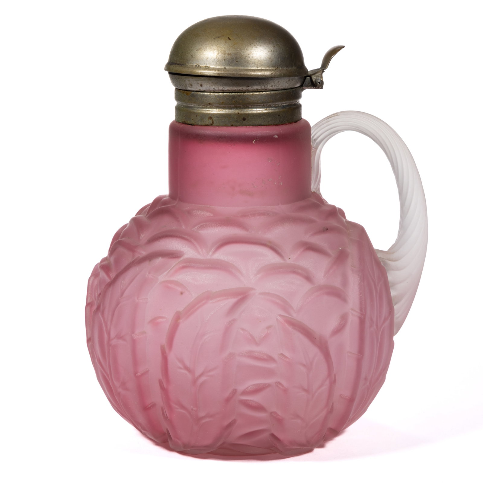 NORTHWOOD NO. 333 / LEAF MOLD SYRUP PITCHER: NORTHWOOD NO. 333 / LEAF MOLD SYRUP PITCHER, Ruby with a satin finish, applied frosted colorless reeded handle, period lid. Northwood Glass Co. Pattern introduced in 1891. 6 1/4" H.Literature: Paralle