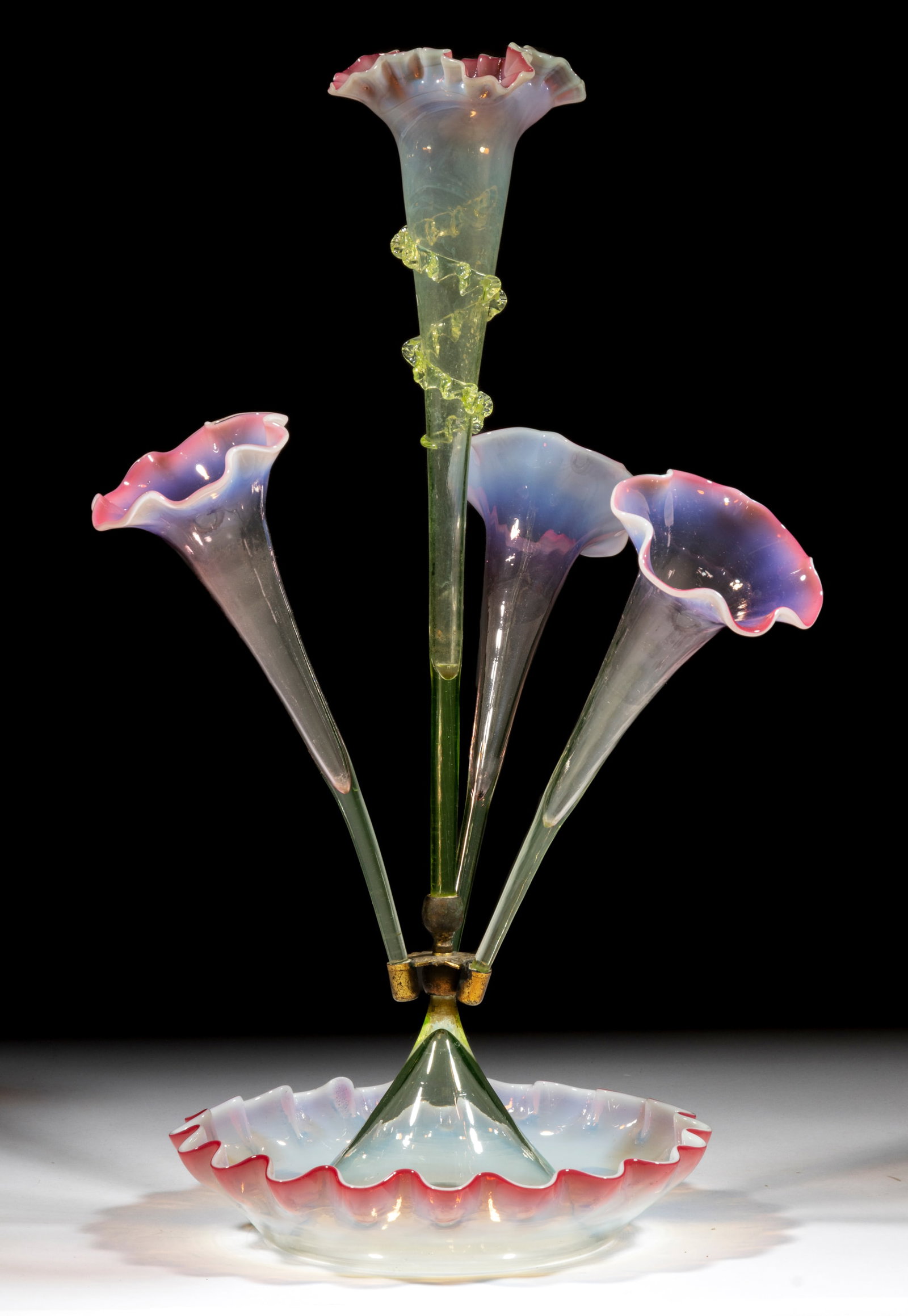 VICTORIAN RUBINA VERDE GLASS EPERGNE: VICTORIAN RUBINA VERDE GLASS EPERGNE, cranberry to Vaseline (reacts under black light), ruffled-rim bowl fitted with four vases, each with applied rigaree decoration, fancy brass vase holder. Fourth q