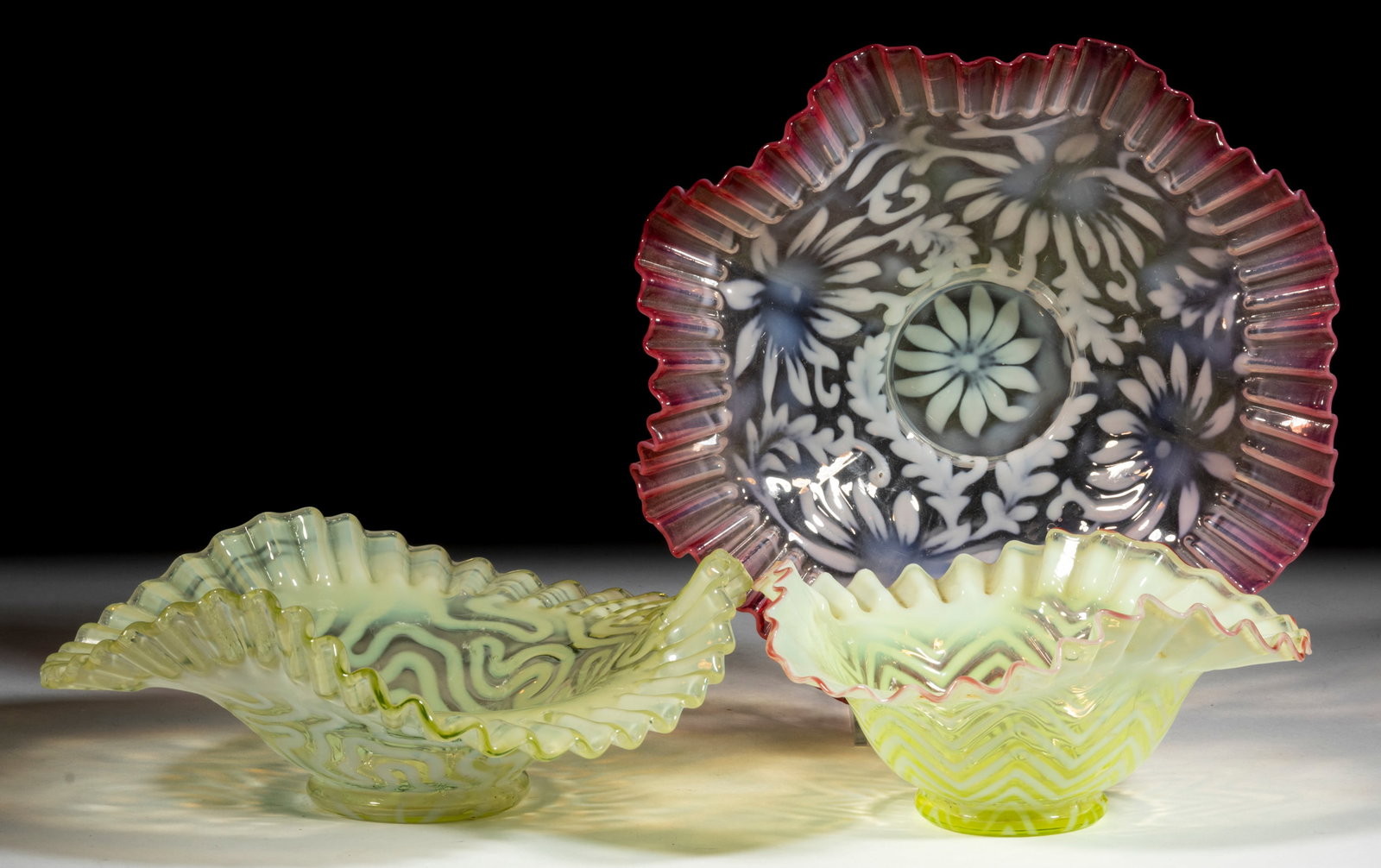 ASSORTED BLOWN OPALESCENT DISHES, LOT OF THREE: ASSORTED BLOWN OPALESCENT DISHES, LOT OF THREE, comprising a Vaseline opalescent (reacts under black light) Herringbone, a Vaseline opalescent (reacts under black light) Swirling Maze, and a rubina op