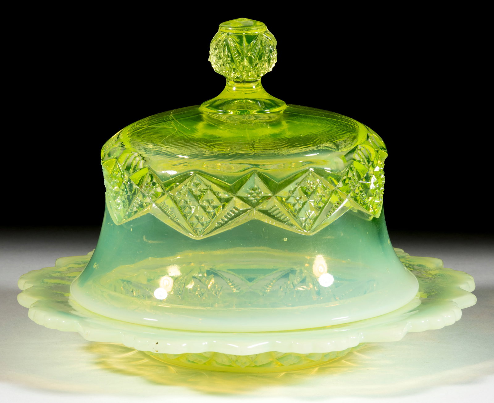 NATIONAL NO. 22 (OMN) / DIAMOND SPEARHEAD COVERED BUTTER DISH: NATIONAL NO. 22 (OMN) / DIAMOND SPEARHEAD COVERED BUTTER DISH, Vaseline opalescent (reacts under black light). Northwood Glass Co./National Glass Co. Pattern introduced 1901. 5 1/2" HOA. Literature: P