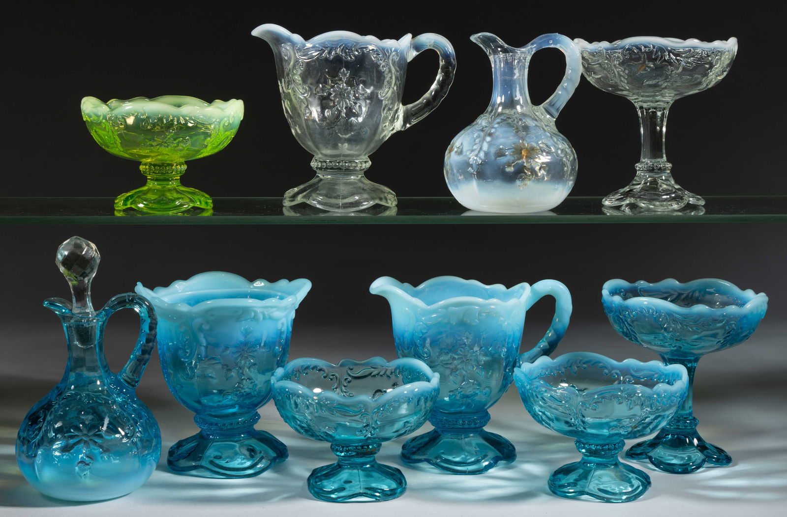 INTAGLIO PRESSED OPALESCENT GLASS ARTICLES, LOT OF TEN: INTAGLIO PRESSED OPALESCENT GLASS ARTICLES, LOT OF TEN, colorless, blue, and Vaseline (reacts under black light), each being opalescent, including two cruets with one having a period stopper and the o