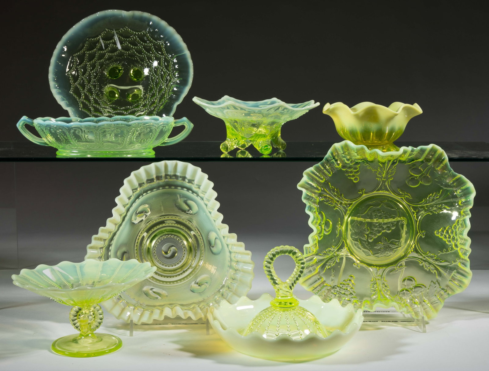 ASSORTED PRESSED OPALESCENT GLASS ARTICLES, LOT OF EIGHT: ASSORTED PRESSED OPALESCENT GLASS ARTICLES, LOT OF EIGHT, Vaseline opalescent (reacts under black light), including an Inverted Fan and Feather footed dish, an Astro footed dish, and a Ring Handled Ba
