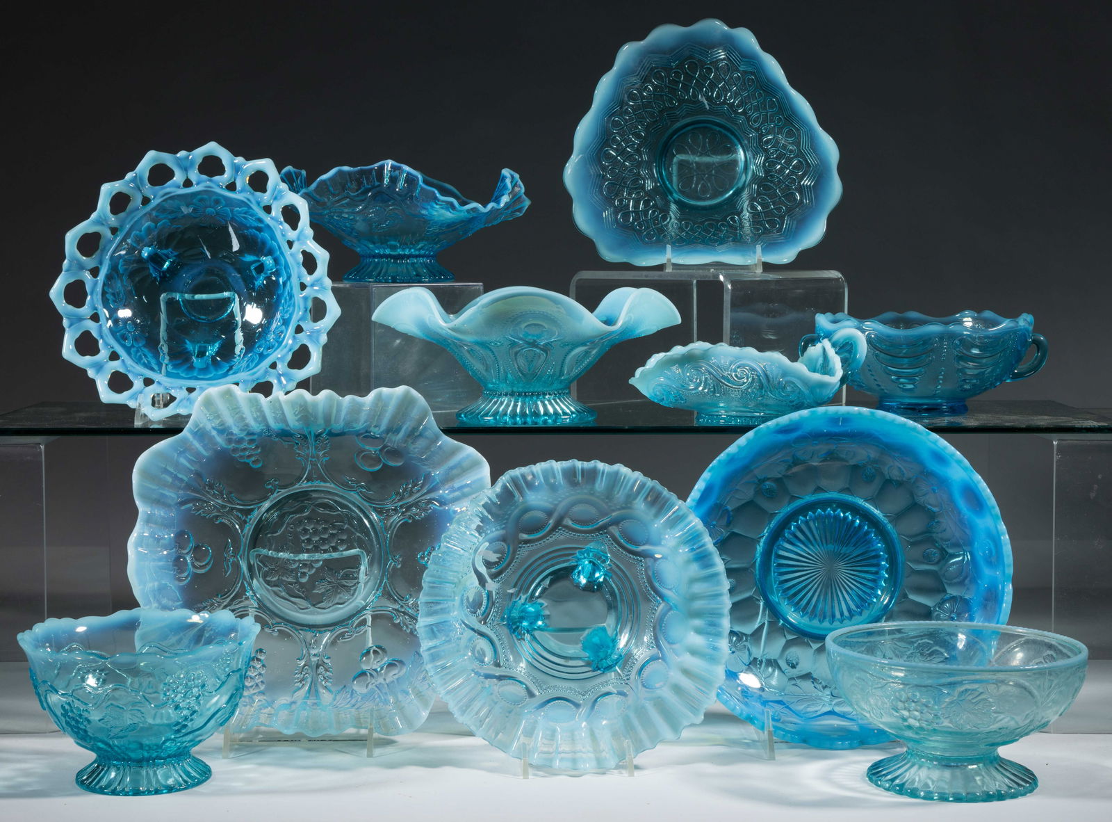 ASSORTED PRESSED OPALESCENT GLASS BOWLS / DISHES, LOT OF 11: ASSORTED PRESSED OPALESCENT GLASS BOWLS / DISHES, LOT OF 11, blue opalescent, including an Astro, a Grapes and Cherries, a Keyhole, and a Vintage. Various makers. Late 19th/early 20th century. 2 1/4"