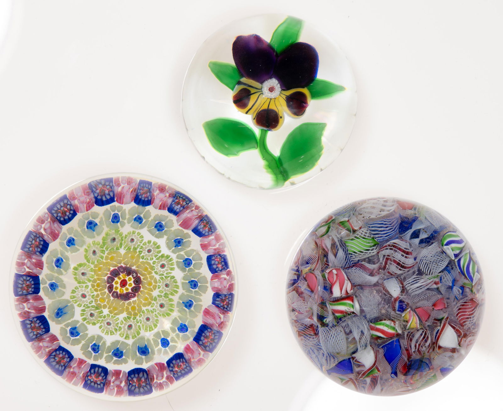 ANTIQUE BACCARAT ART GLASS PAPERWEIGHTS, LOT OF THREE: ANTIQUE BACCARAT ART GLASS PAPERWEIGHTS, LOT OF THREE, comprising a miniature Pansy, a scrambled, and a Vintage concentric millefiori. The Compagnie des Verreries et Cristalleries de Baccarat. 19th an