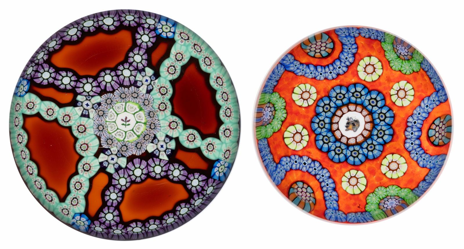 VINTAGE PERTHSHIRE MILLEFIORI ART GLASS PAPERWEIGHTS, LOT OF TWO: VINTAGE PERTHSHIRE MILLEFIORI ART GLASS PAPERWEIGHTS, LOT OF TWO, comprising a central purple flower silhouette cane, encircled by two interior garlands of complex canes, exterior with amethyst and wh