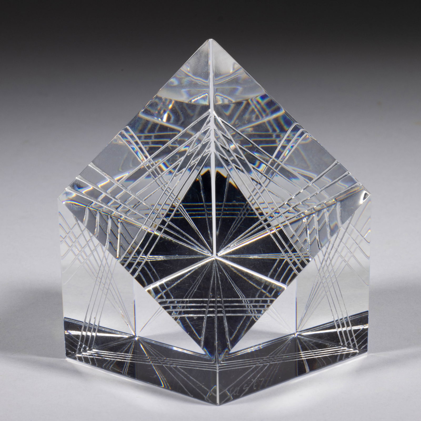 JAMES SHAW (AMERICAN, B. 1953) OPTIC CUBE STUDIO ART GLASS PAPERWEIGHT: JAMES SHAW (AMERICAN, B. 1953) OPTIC CUBE STUDIO ART GLASS PAPERWEIGHT, colorless, diagonal diamond face with optical cuts to the base and side creating a triangle with rays when looking through the f