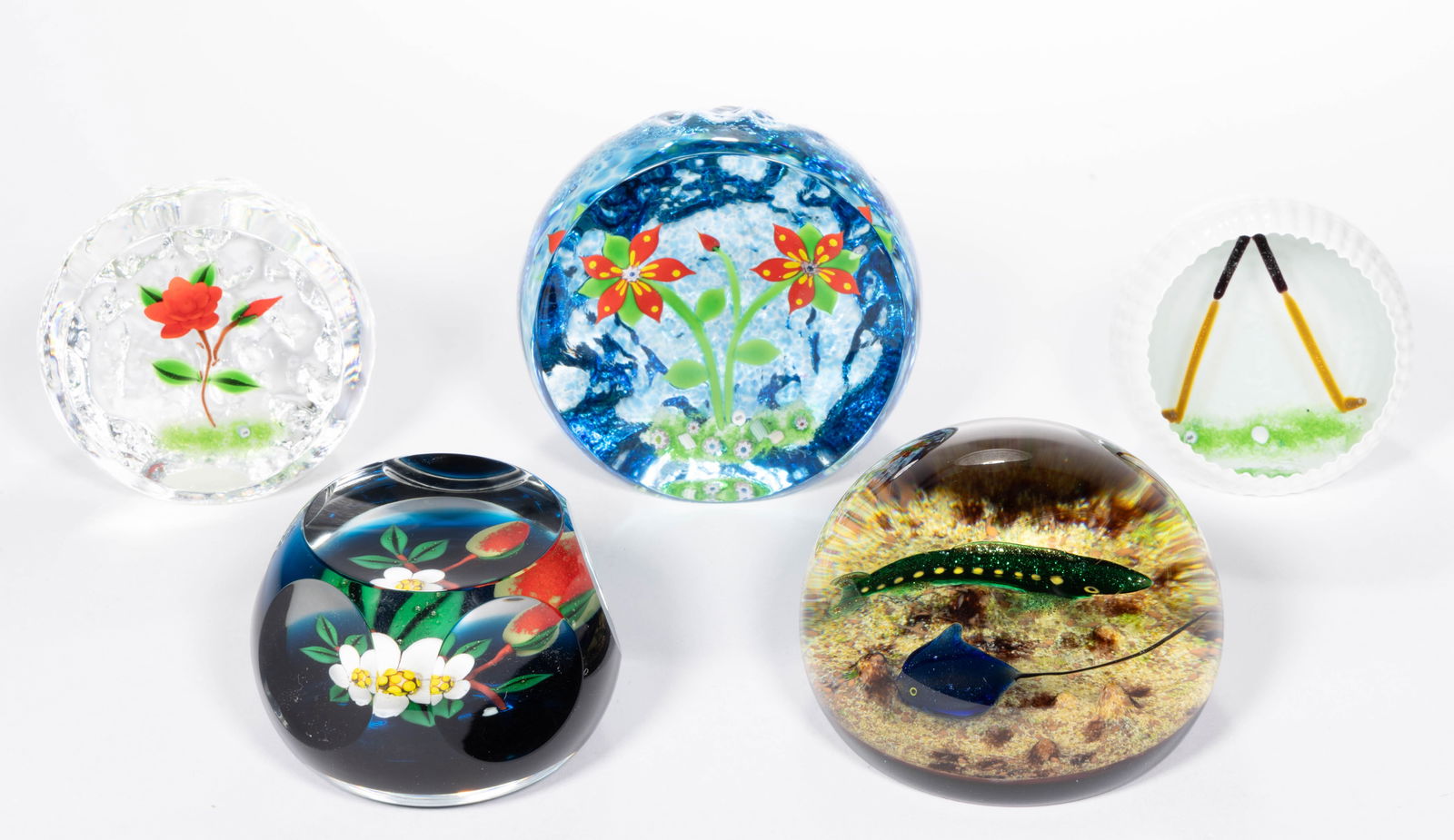 WILLIAM MANSON (SCOTTISH, B. 1951) ART GLASS PAPERWEIGHTS, LOT OF FIVE: WILLIAM MANSON (SCOTTISH, B. 1951) ART GLASS PAPERWEIGHTS, LOT OF FIVE, including a Gold example with the exterior as a golf ball, a stingray and a fish, and two floral examples with textured surfaces