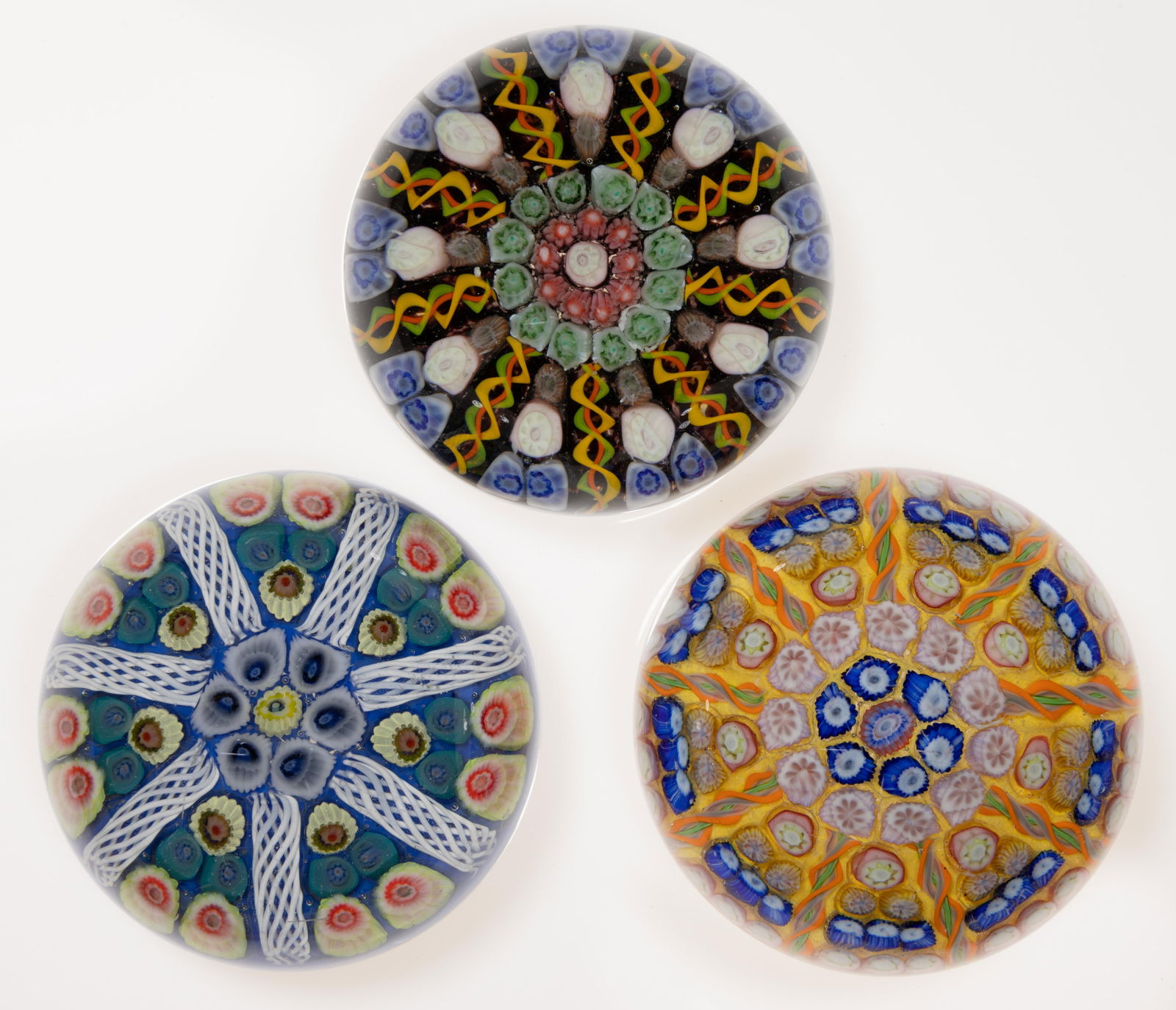 SCOTTISH WEDGE MILLEFIORI ART GLASS PAPERWEIGHTS, LOT OF THREE: SCOTTISH WEDGE MILLEFIORI ART GLASS PAPERWEIGHTS, LOT OF THREE, comprising one having six wedges and two having eight wedges, each having stacked millefiori canes separated by filigree twists, one hav