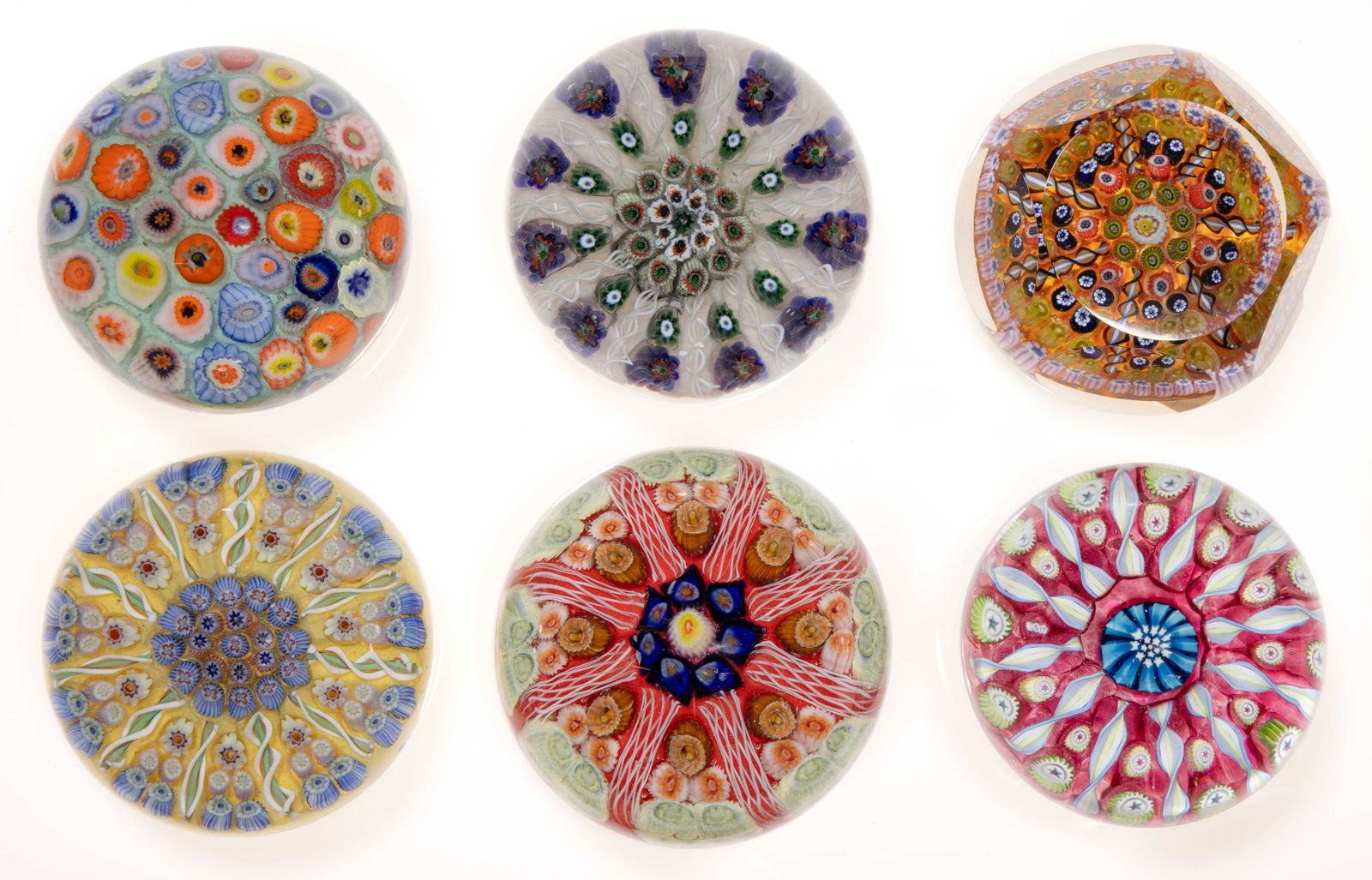 SCOTTISH MILLEFIORI ART GLASS PAPERWEIGHTS, LOT OF SIX: SCOTTISH MILLEFIORI ART GLASS PAPERWEIGHTS, LOT OF SIX, comprising five wedge examples and a close-pack, each having a variety of canes in many colors. Scotland. 20th century. 1 1/2" to 2" H, 2.45" to