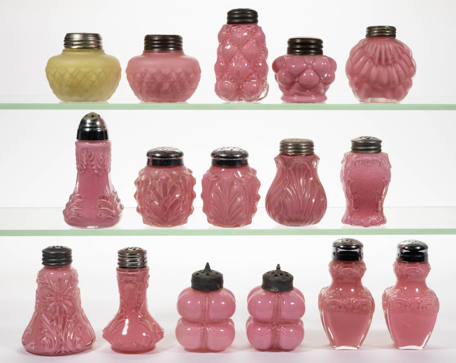ASSORTED CONSOLIDATED / FOSTORIA GLASS SALT AND PEPPER SHAKERS, LOT OF 16: ASSORTED CONSOLIDATED / FOSTORIA GLASS SALT AND PEPPER SHAKERS, LOT OF 16, opal-cased pink and yellow, three with satin finish, including Cotton Bale, Half Cone, Panelled Shell, Long Petal Daisy, Rib 