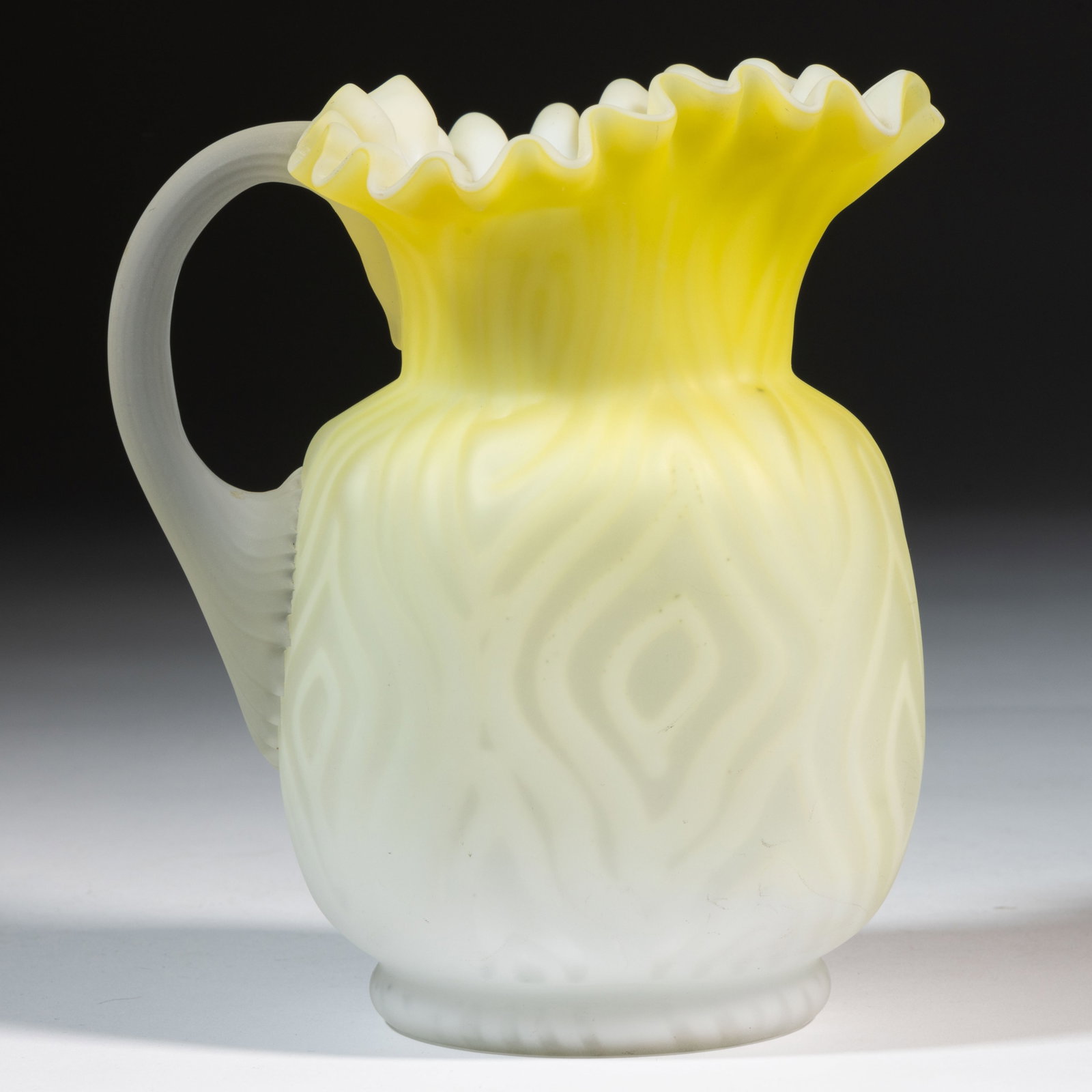 PHOENIX MOIRE AIR-TRAP MOTHER-OF-PEARL SATIN ART GLASS CREAM PITCHER: PHOENIX MOIRE AIR-TRAP MOTHER-OF-PEARL SATIN ART GLASS CREAM PITCHER, shaded yellow cased colorless with opal interior and all-over satin finish, Moire air-trap pattern over compressed oval-form body 